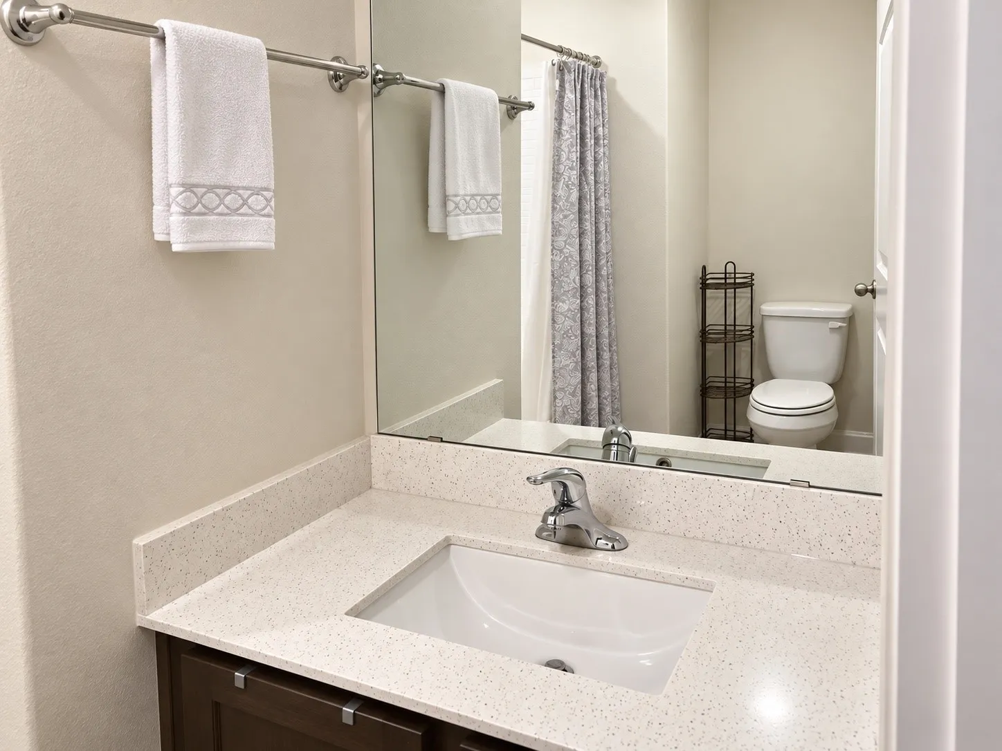 Vanity with a white sink, chrome faucet, and integrated countertop