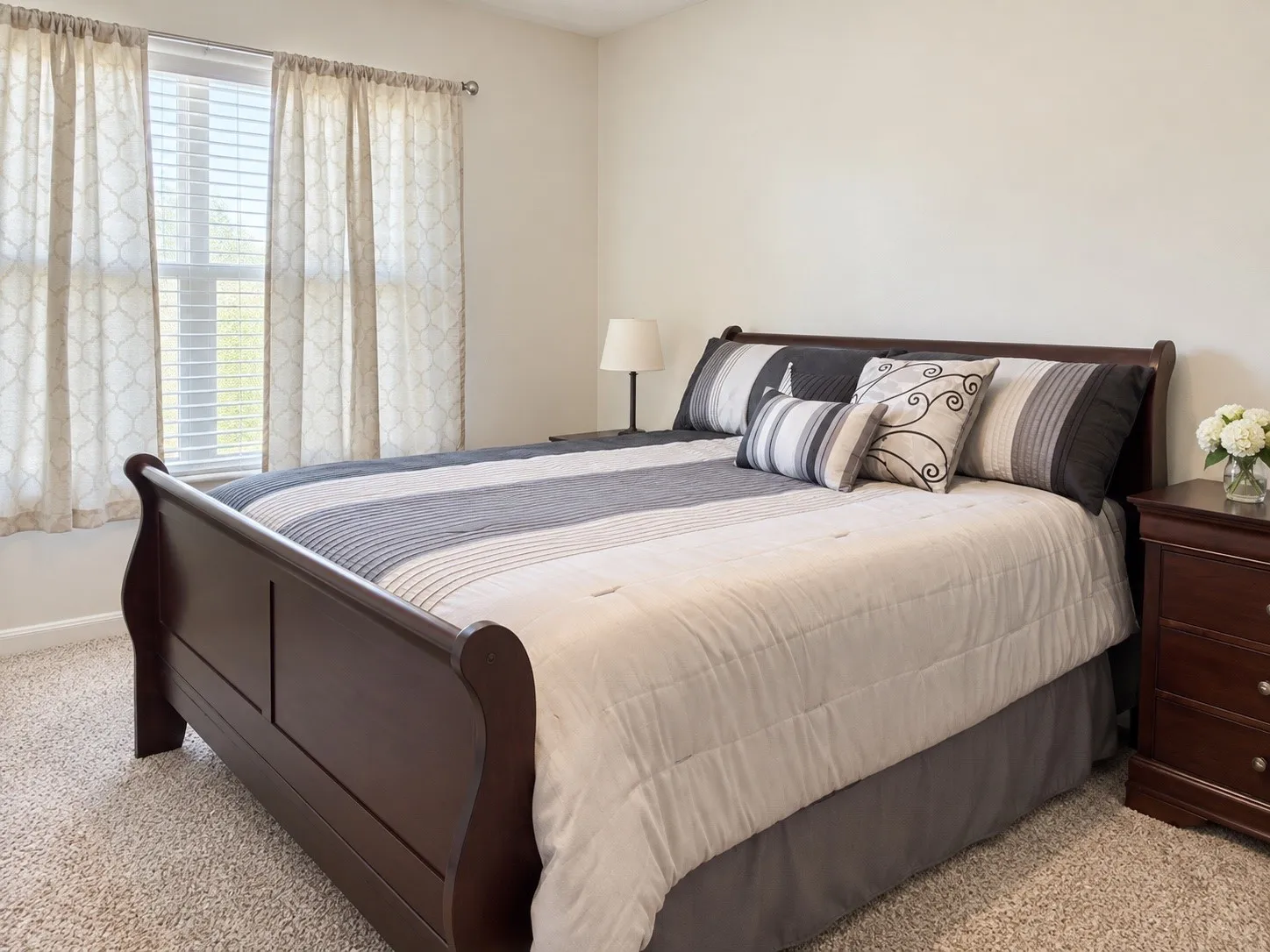 Neutral wall color with a window featuring blinds