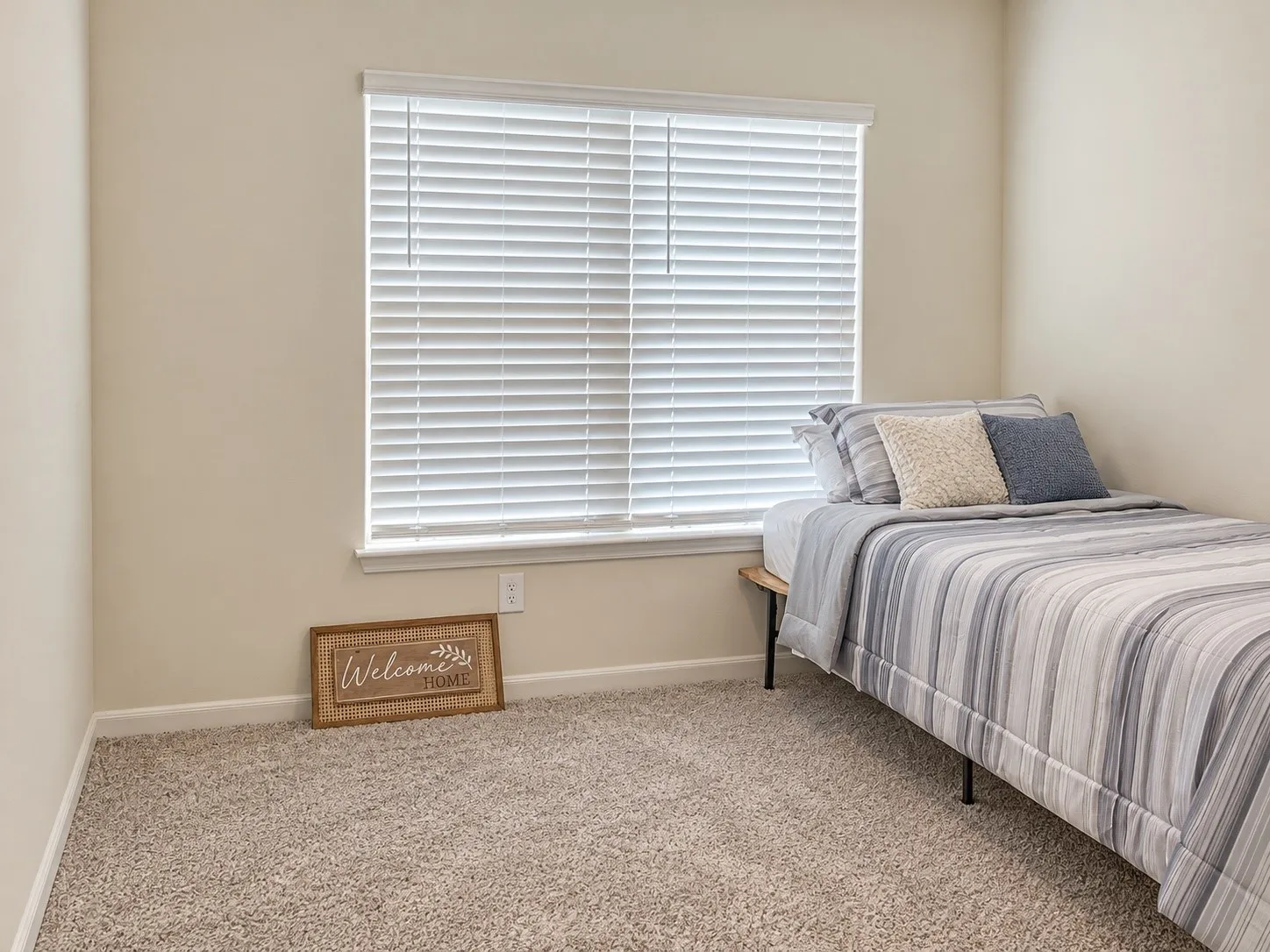 Window with horizontal blinds and light neutral-toned walls