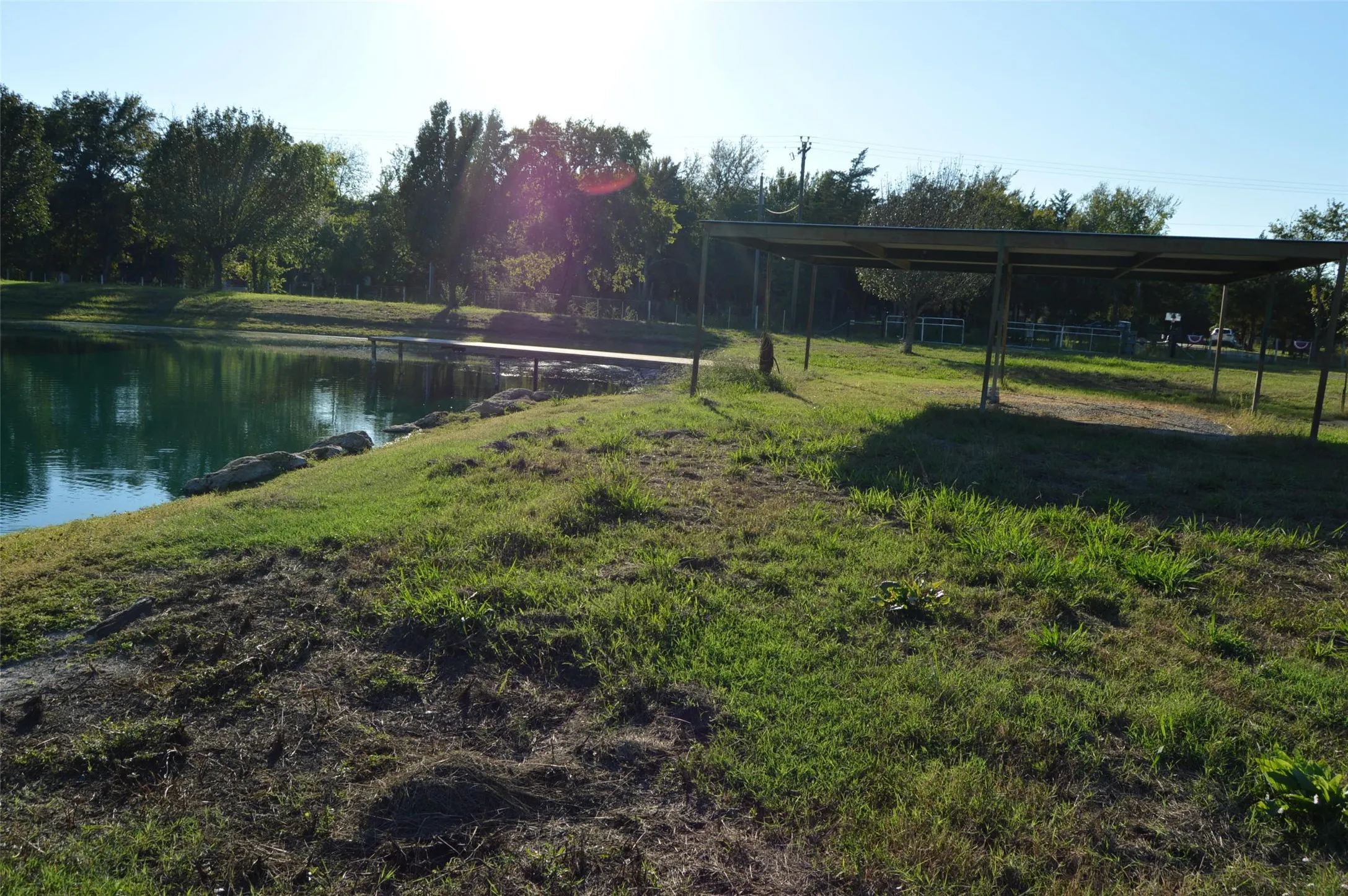 Pond view with covered area canopy and carport