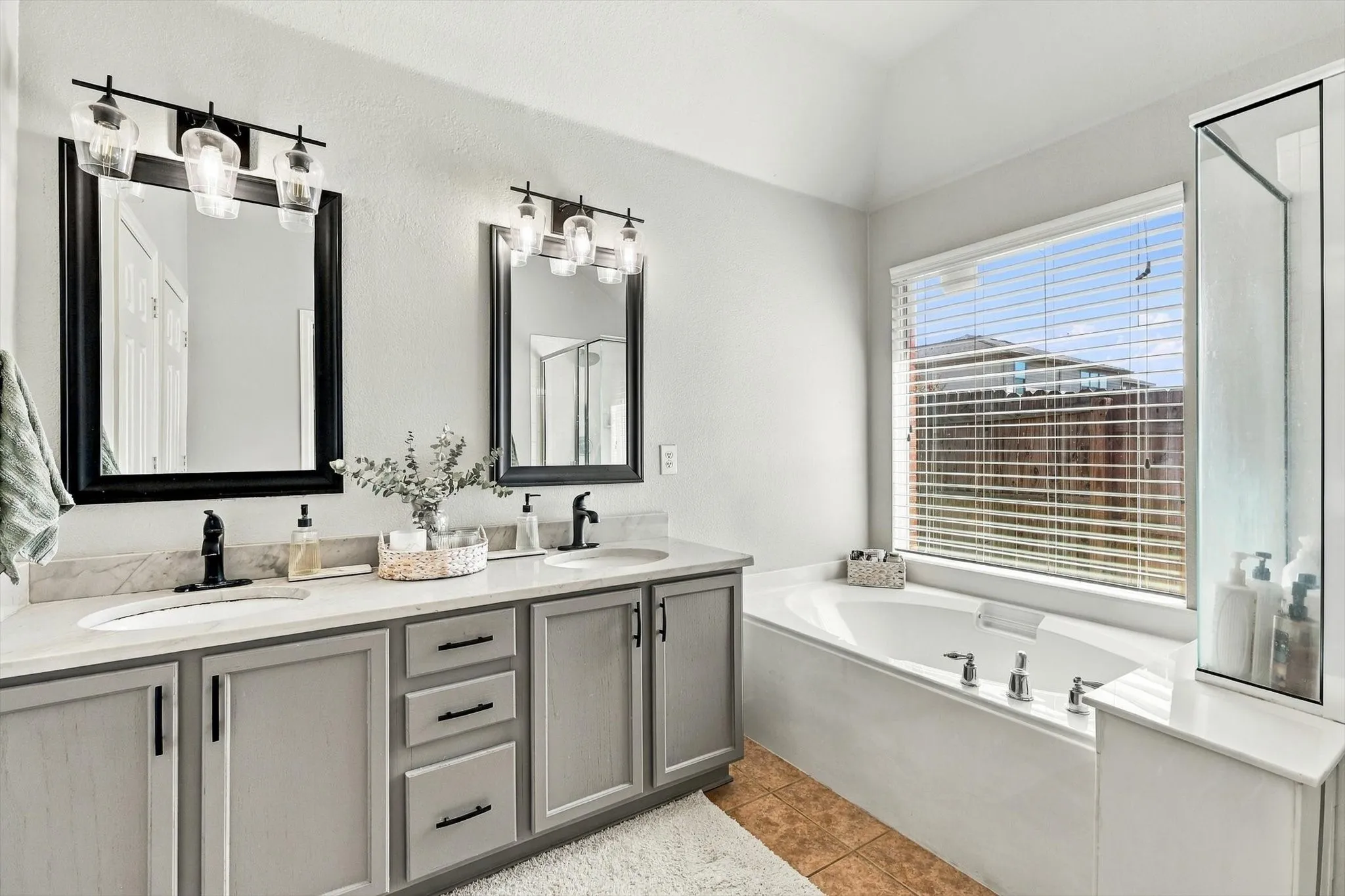 Dual vanity with gray cabinetry and black hardware