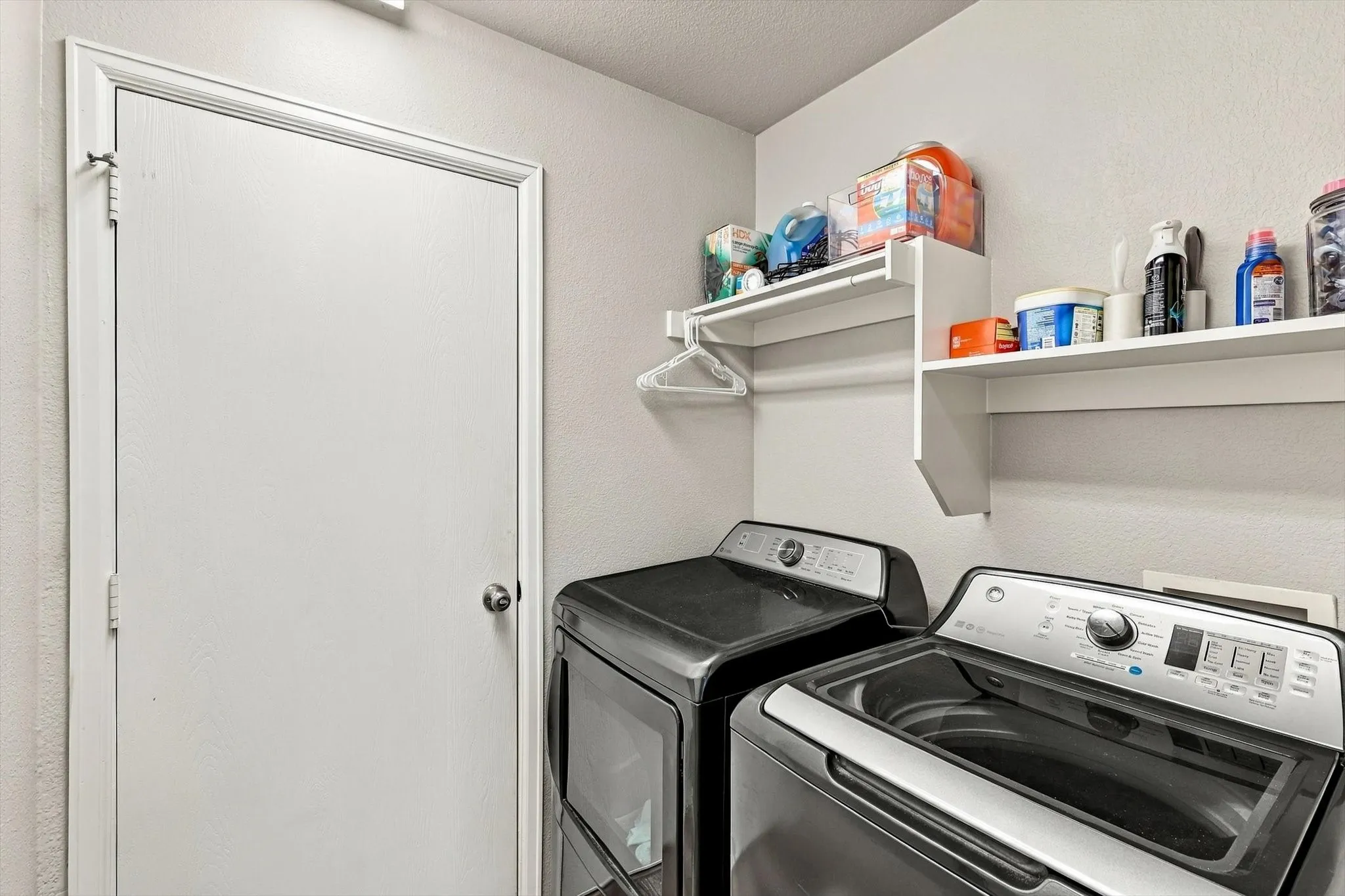 Built-in shelving with hanging rod, and textured wall finish