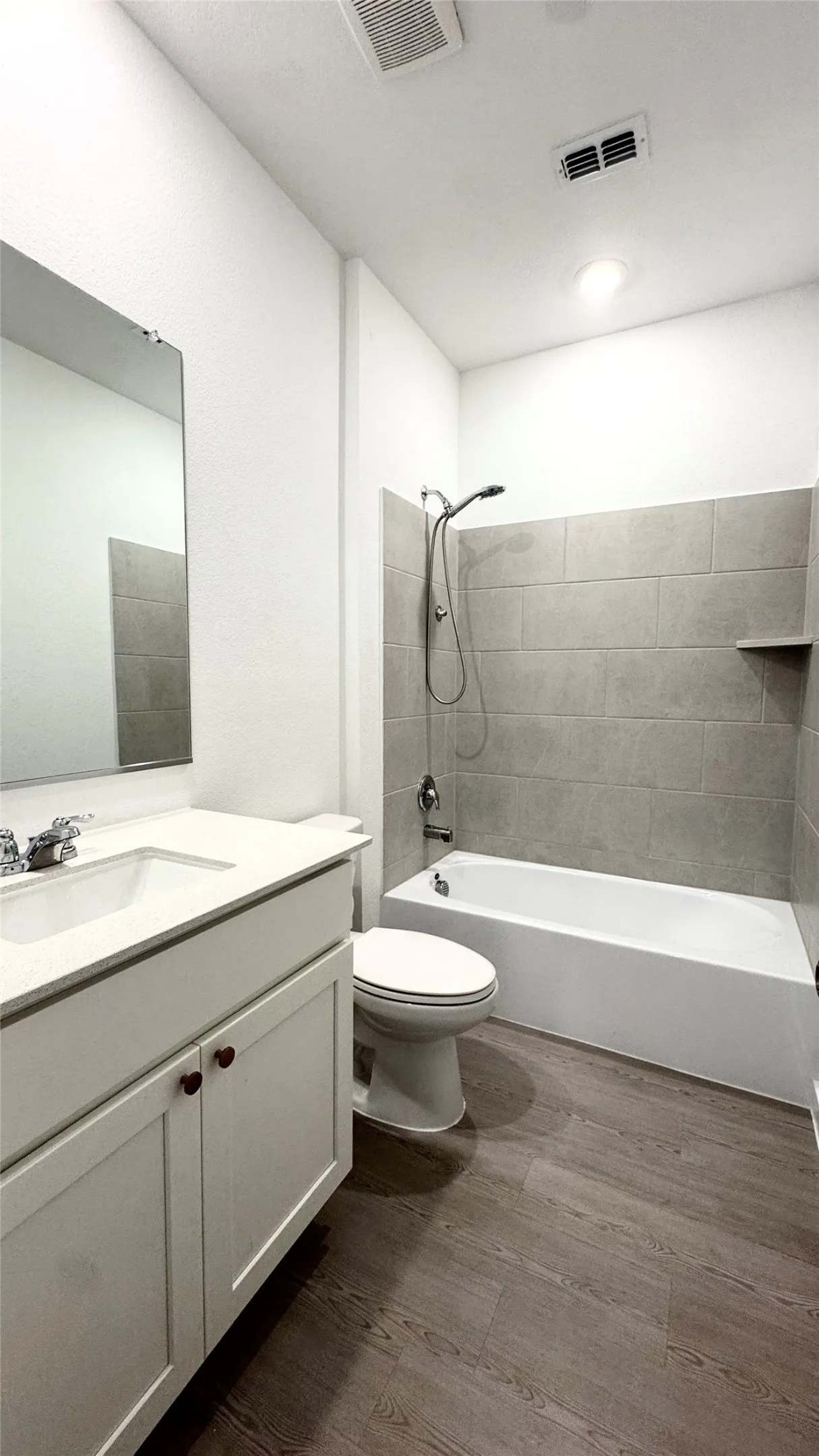 Vanity with white cabinetry, integrated sink, and countertop