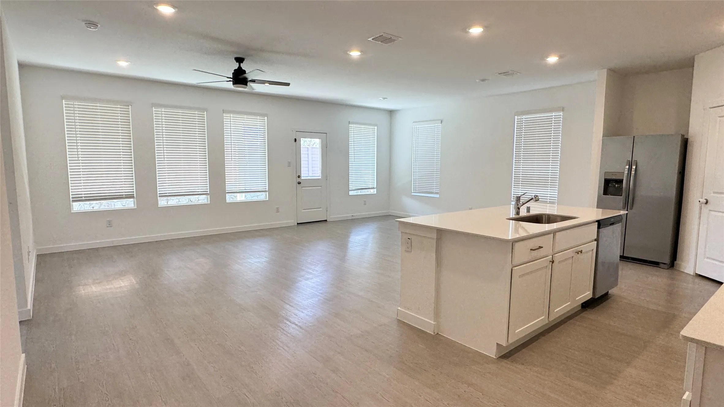 Open-concept living area featuring wood-finish flooring, recessed lighting, and a ceiling​​‌​​​​‌​​‌‌​‌‌​​​‌‌​‌​‌​‌​​​‌​​ fan