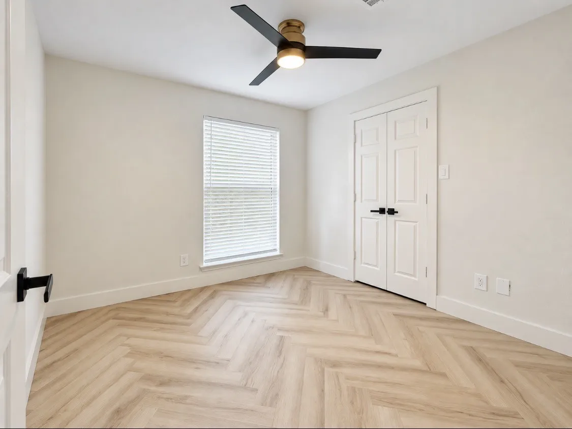 Spacious third bedroom with neutral finishes and flexible space to make your own.