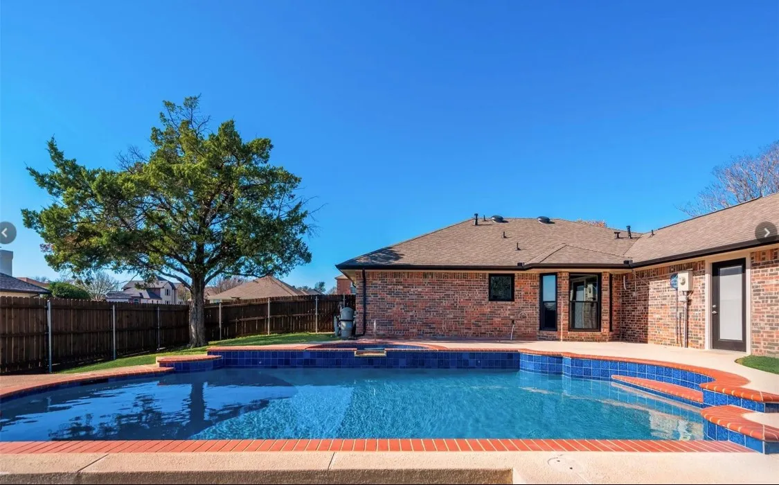 Beautiful backyard pool with a depth of up to 8 feet and an attached heated spa.