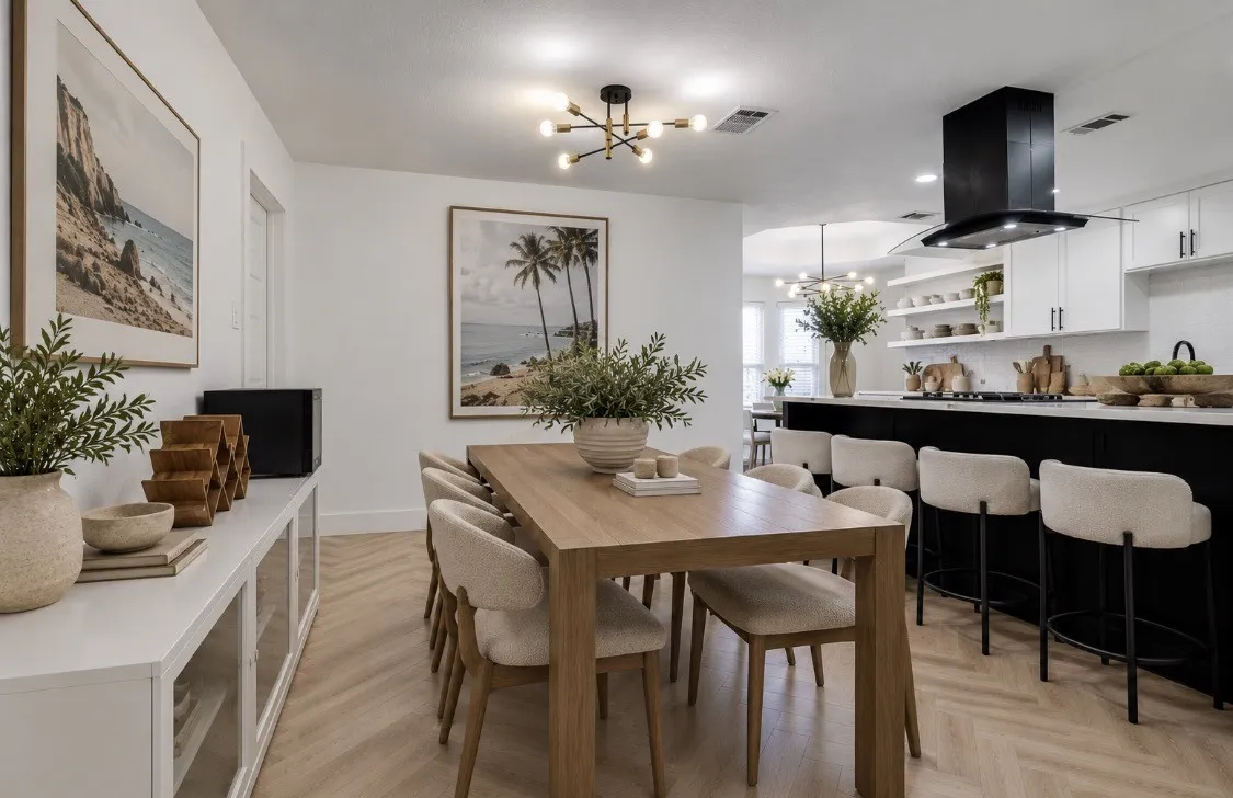 Open dining area with contemporary lighting and convenient access to the kitchen.