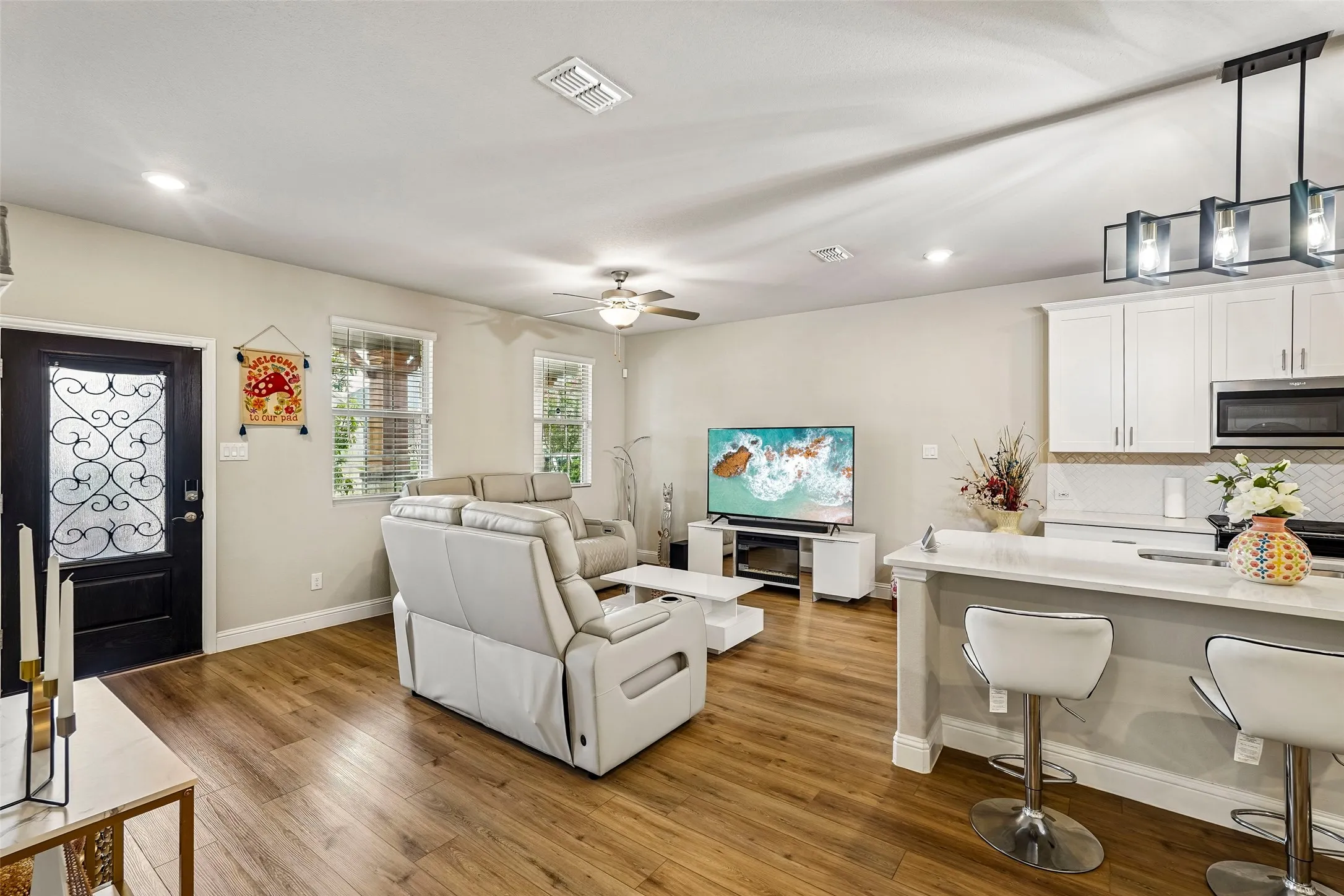 Open-concept living space with wood-finish flooring