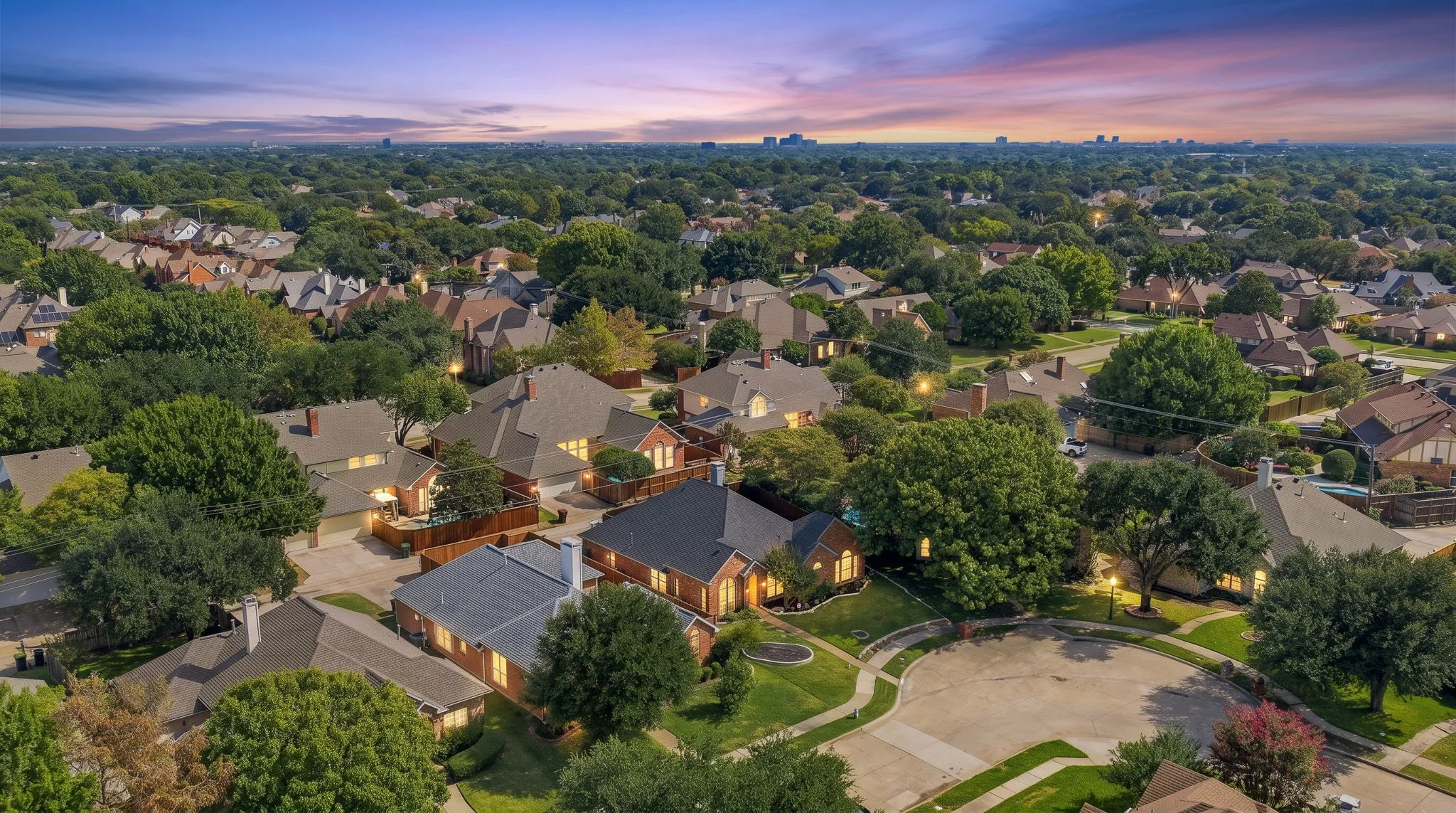 Established residential neighborhood with mature trees, varied architectural styles, and a cul-de-sac street pattern