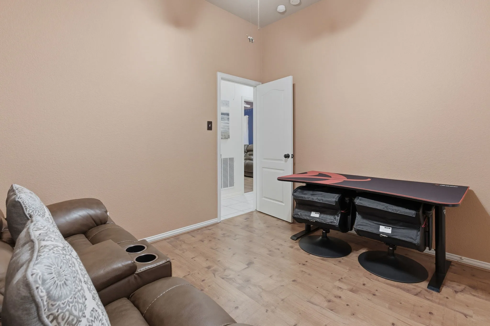 Wood-finish flooring with neutral wall paint and white trim