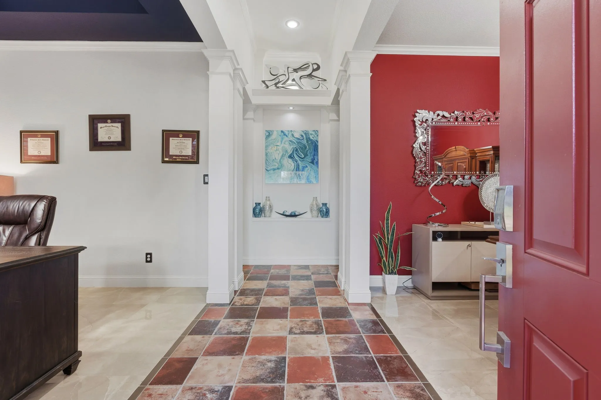 Foyer featuring multi-toned tile flooring, recessed lighting, and decorative columns