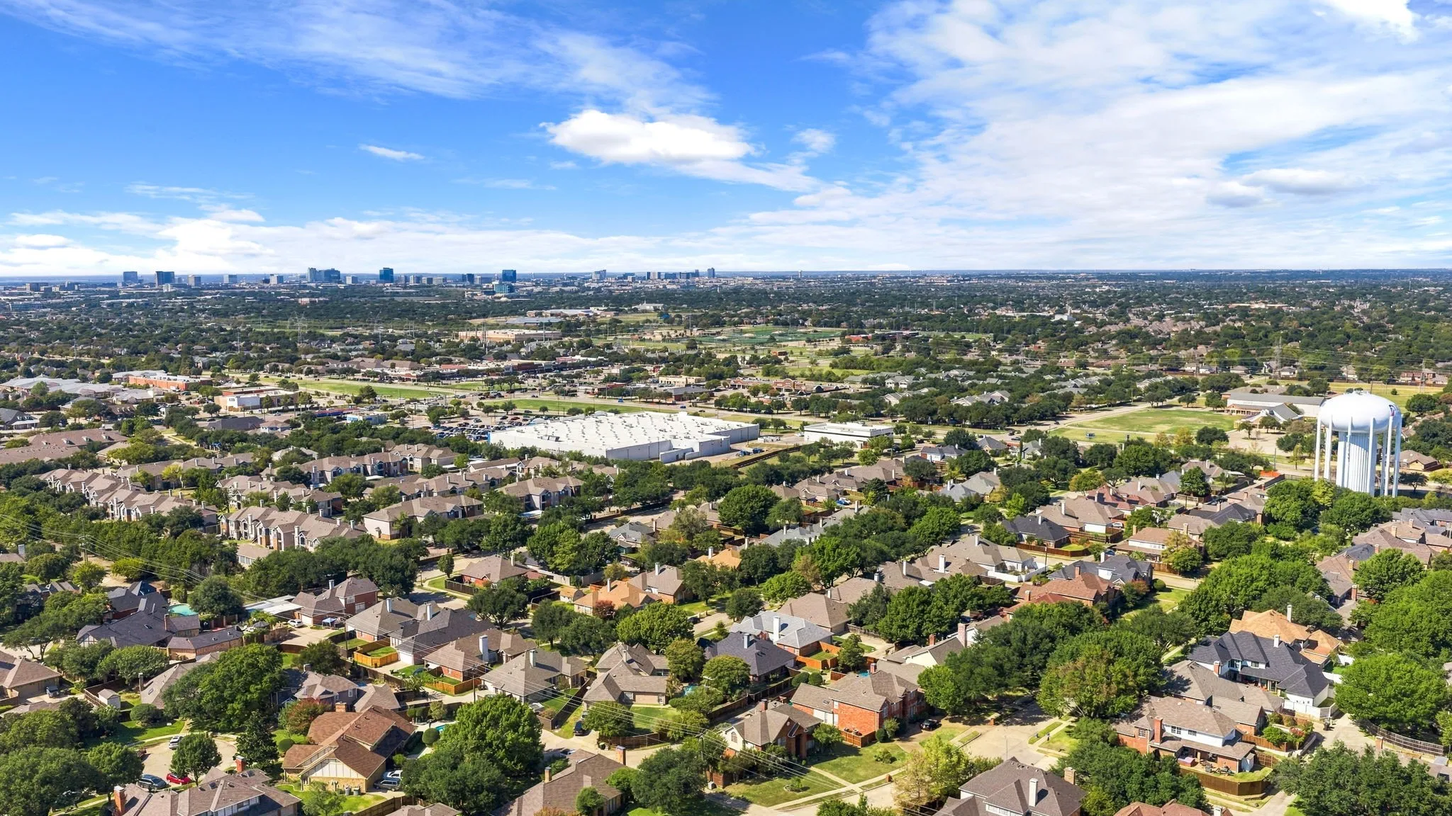 Expansive residential neighborhood with abundant mature trees and a prominent water tower