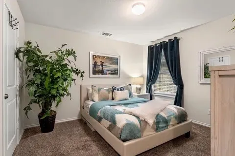 Wall-to-wall carpeting and a ceiling-mounted light fixture