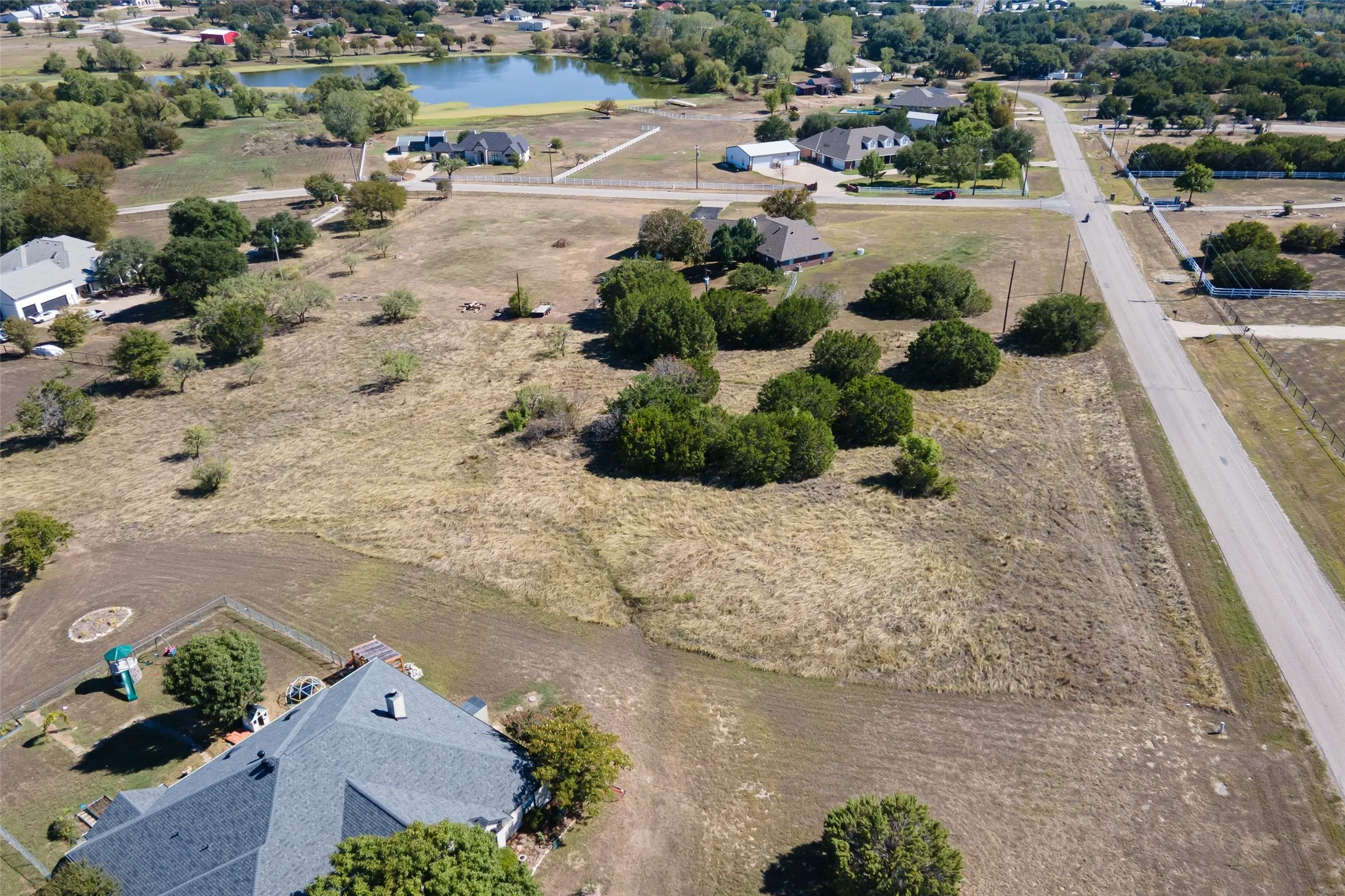 Expansive land parcel featuring natural terrain and scattered mature trees