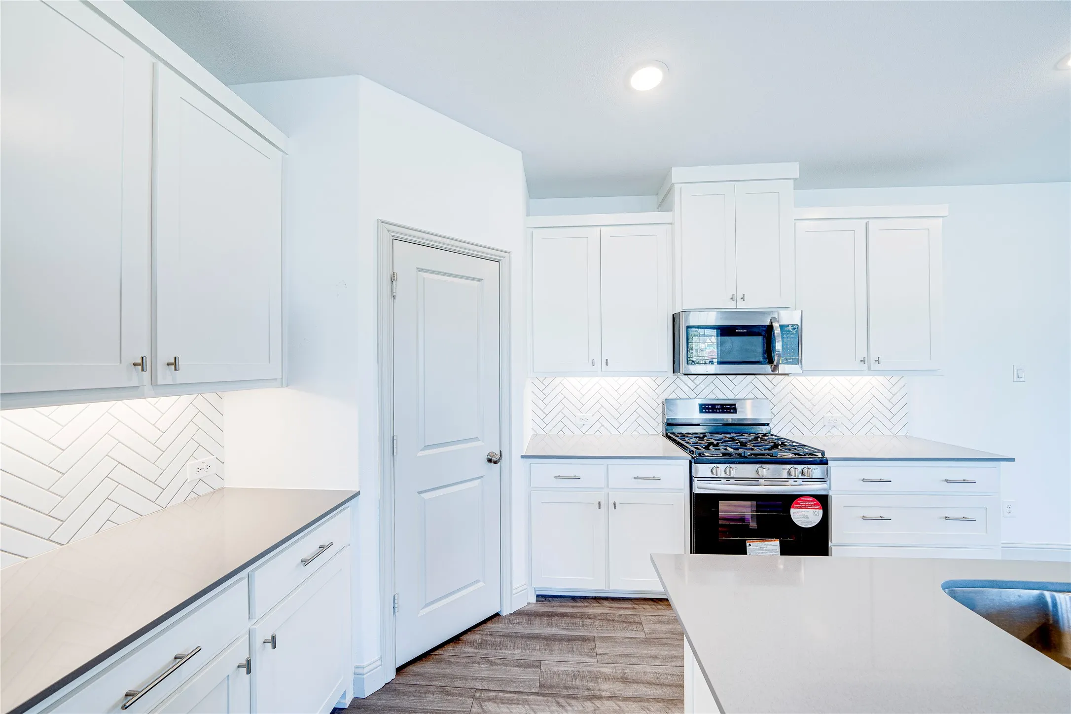 White shaker-style cabinetry with matte silver hardware