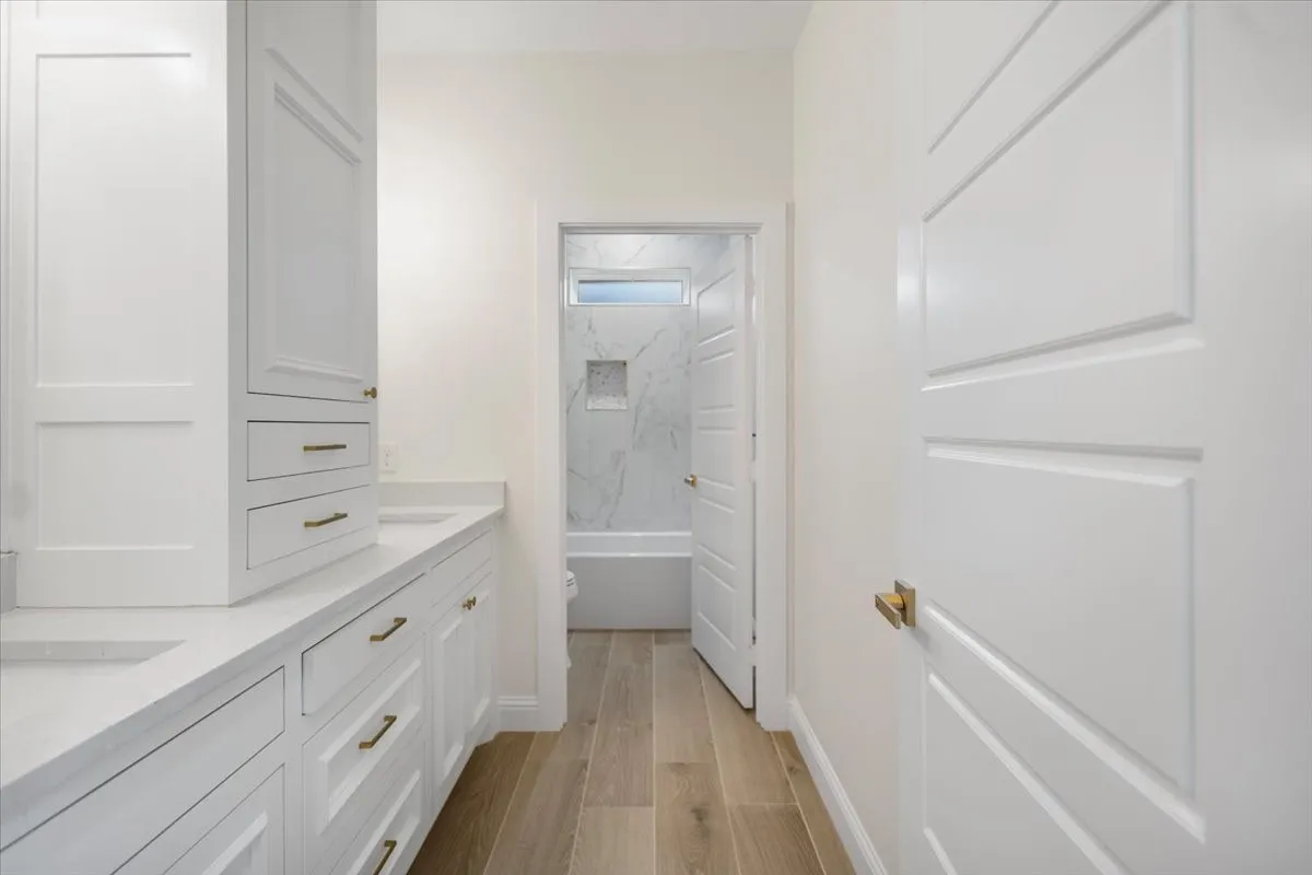 Dual vanity with integrated sinks and white cabinetry
