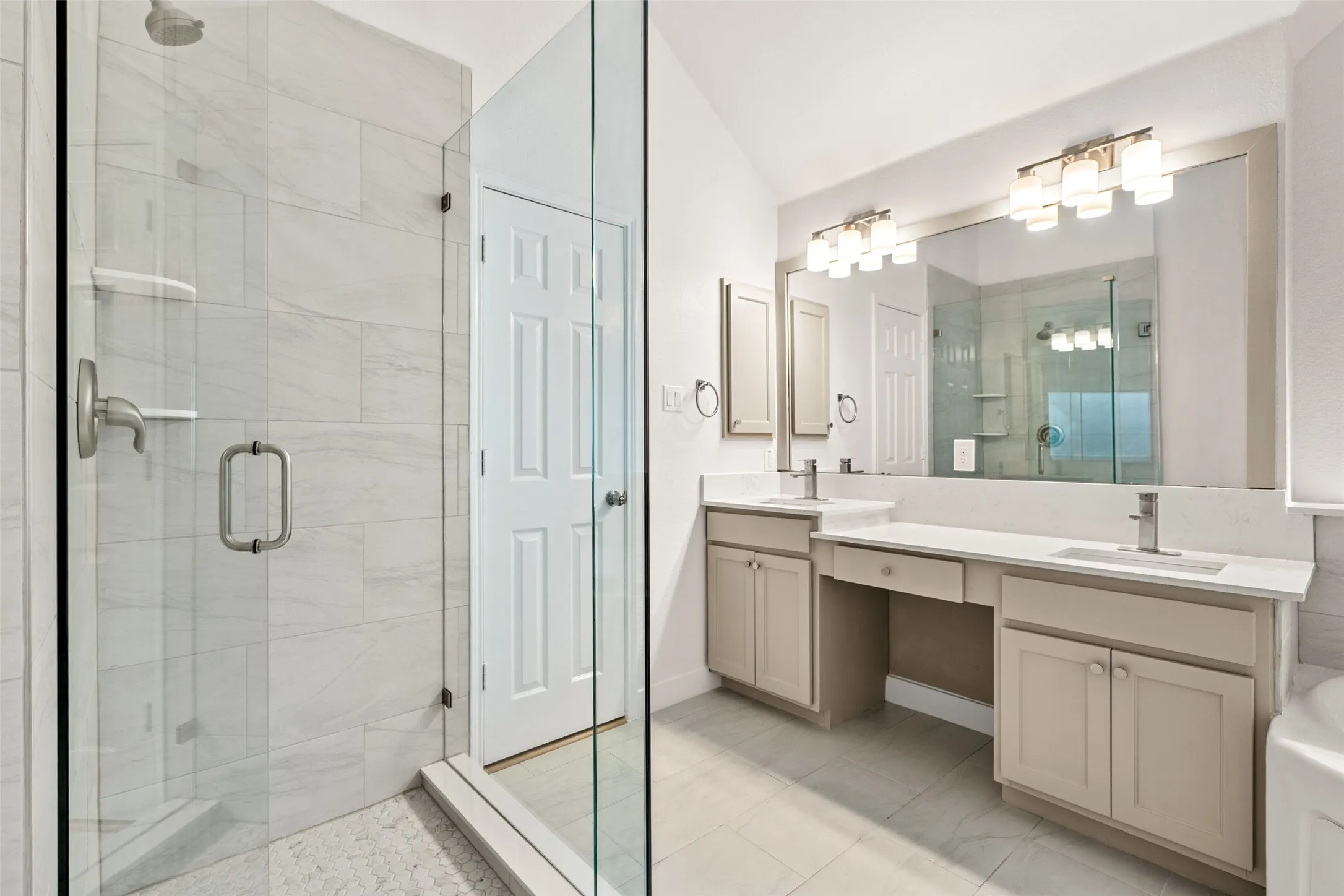 Dual vanity with undermount sinks, stone countertops, and ample storage cabinetry