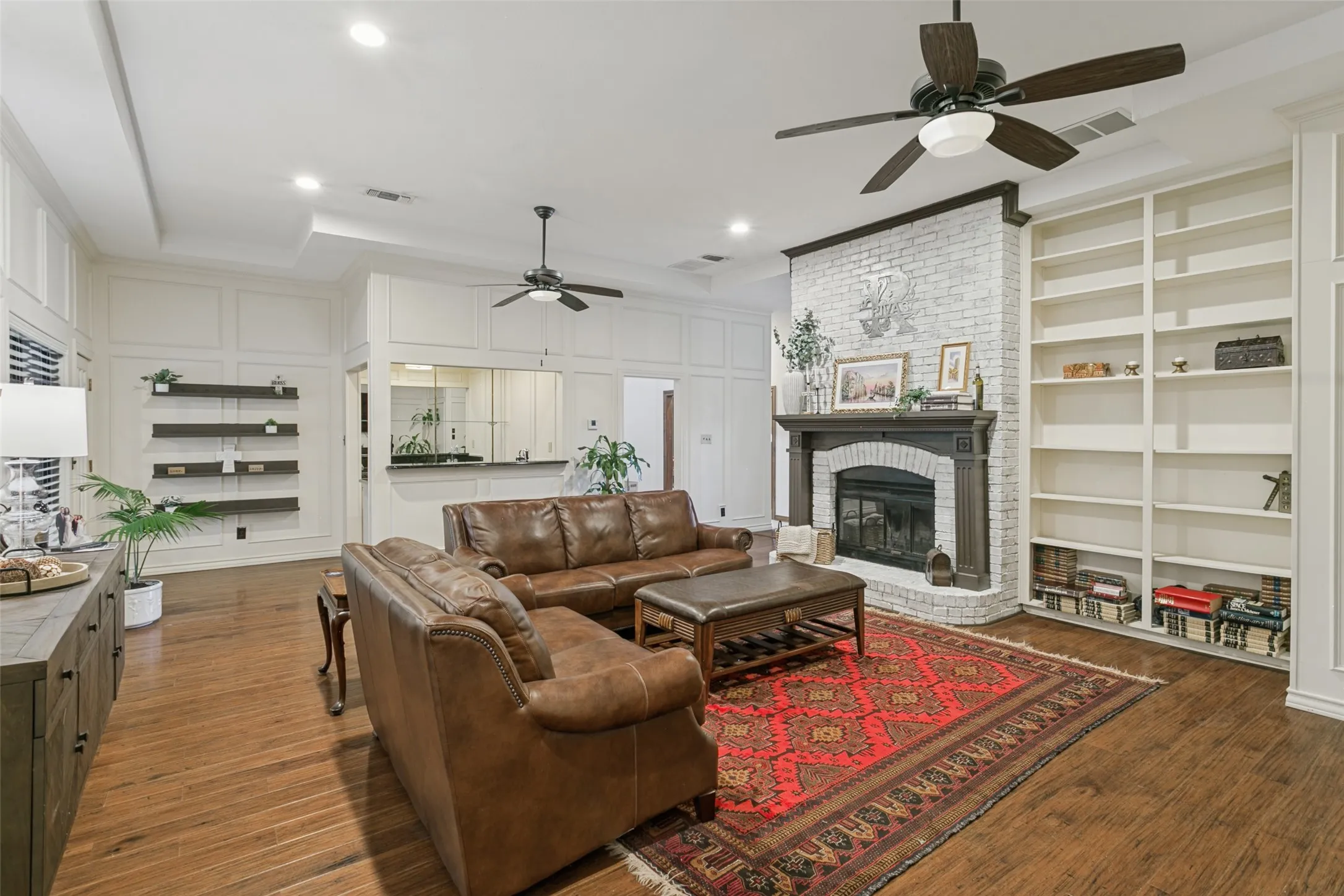 Dual Ceiling fans, floating shelves and a wet bar enhance the living rea