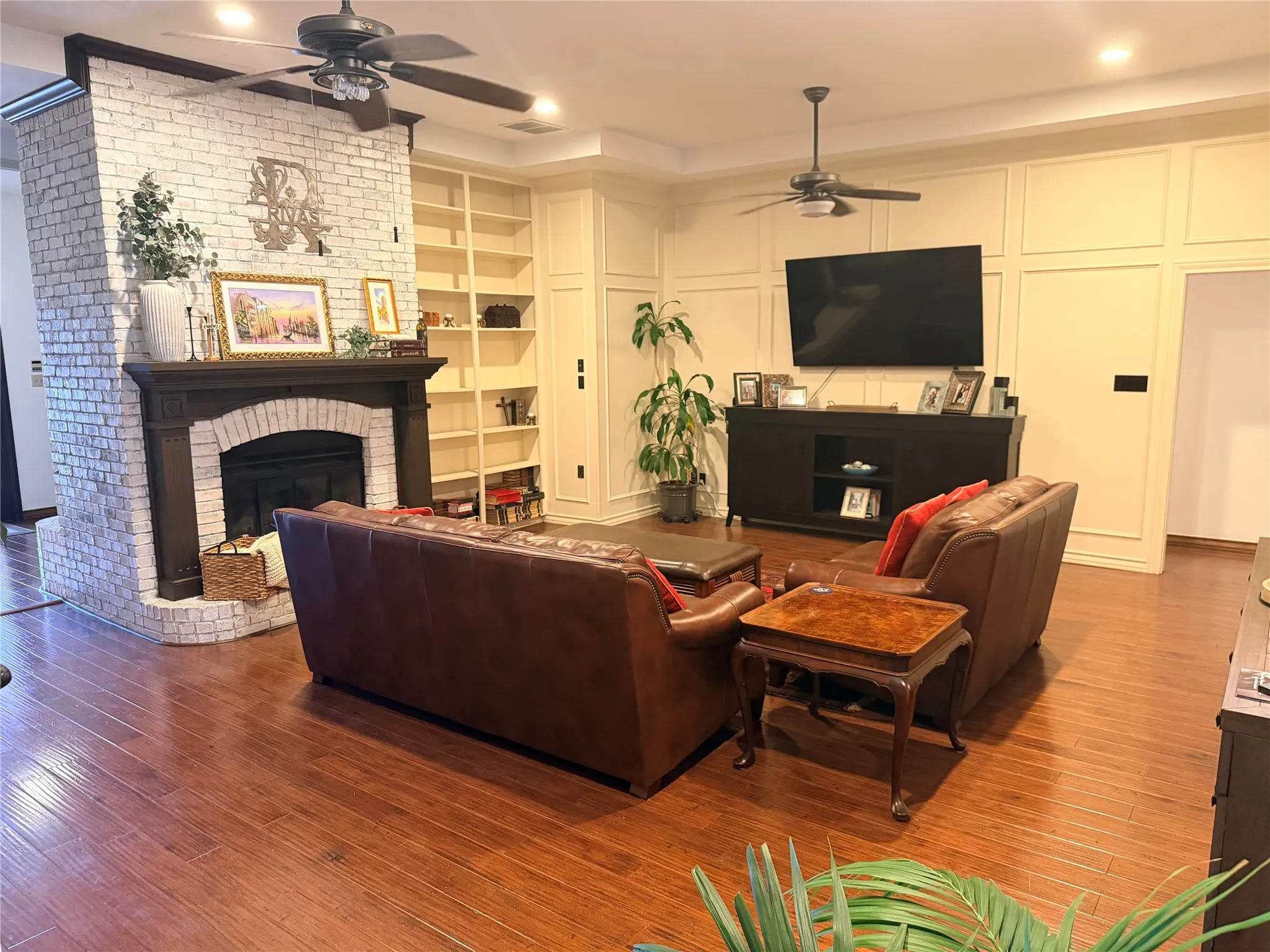 Warm living room with book shelves and fireplace