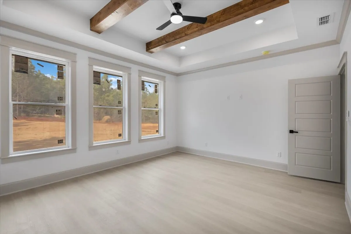 Tray ceiling with wood-finish beams and recessed lighting