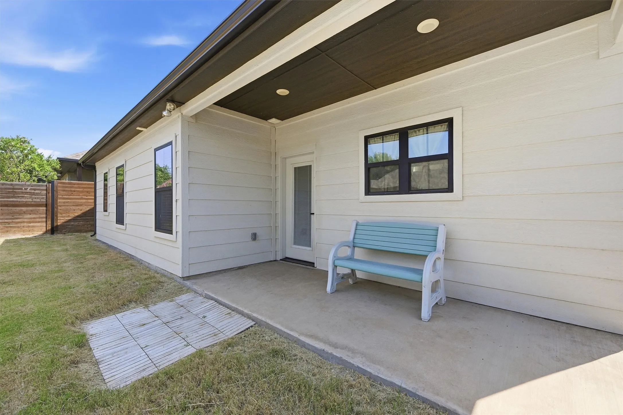Rear exterior with covered patio, recessed lighting, and horizontal siding