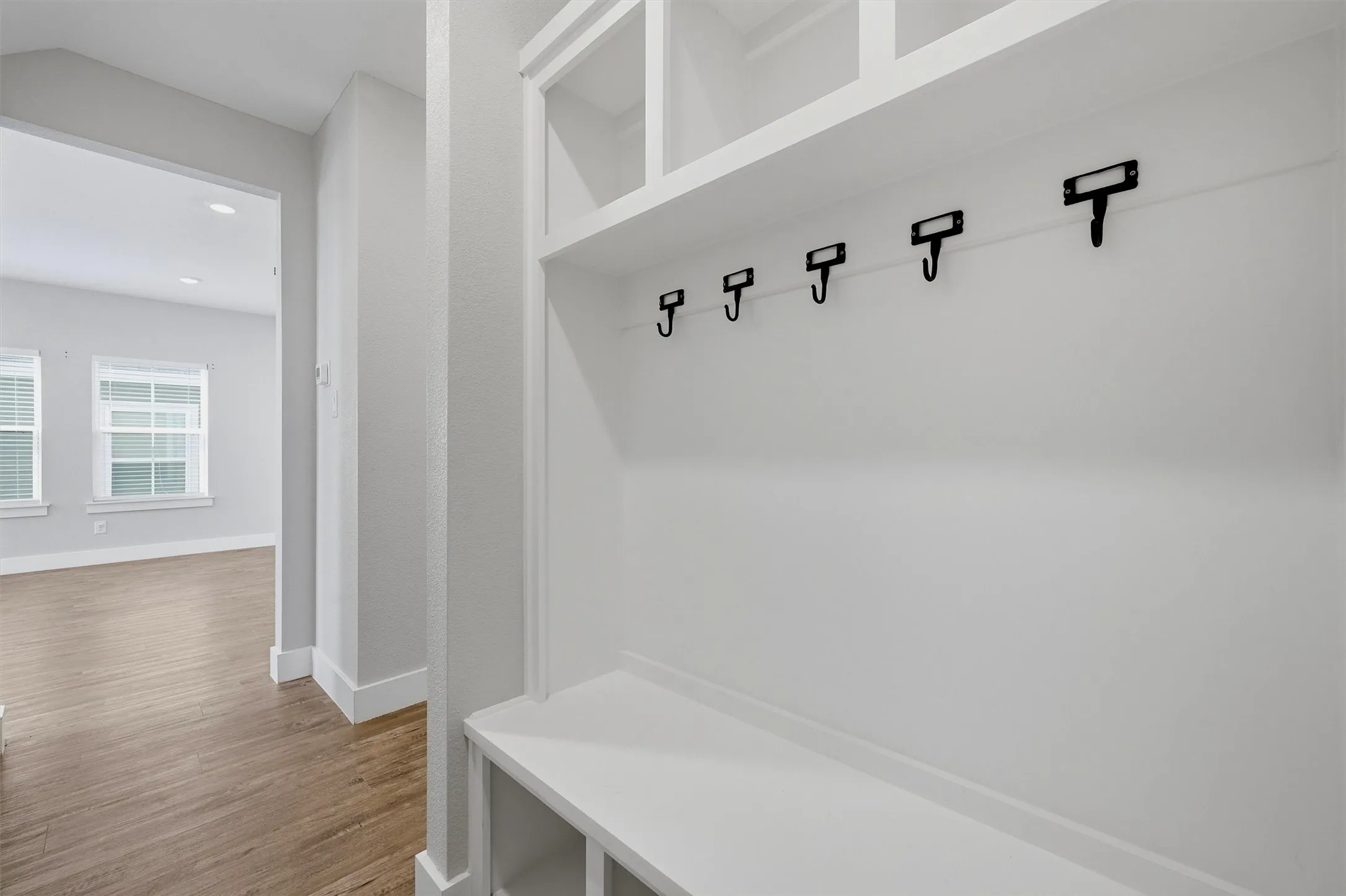 Built-in entryway storage with shelving and coat hooks