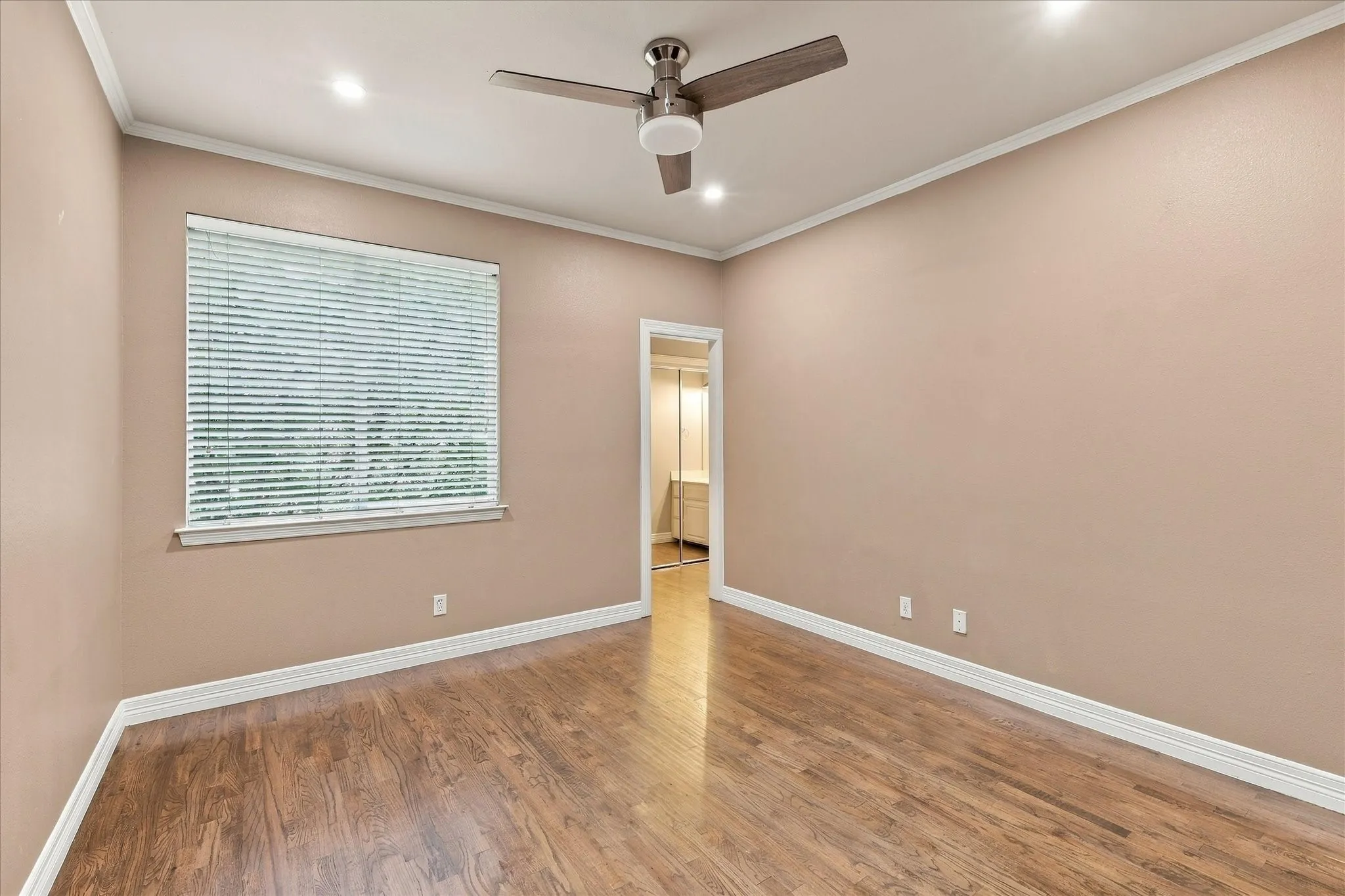 Room featuring wood-finish flooring, a ceiling fan with integrated lighting, recessed lighting, and a window with blinds