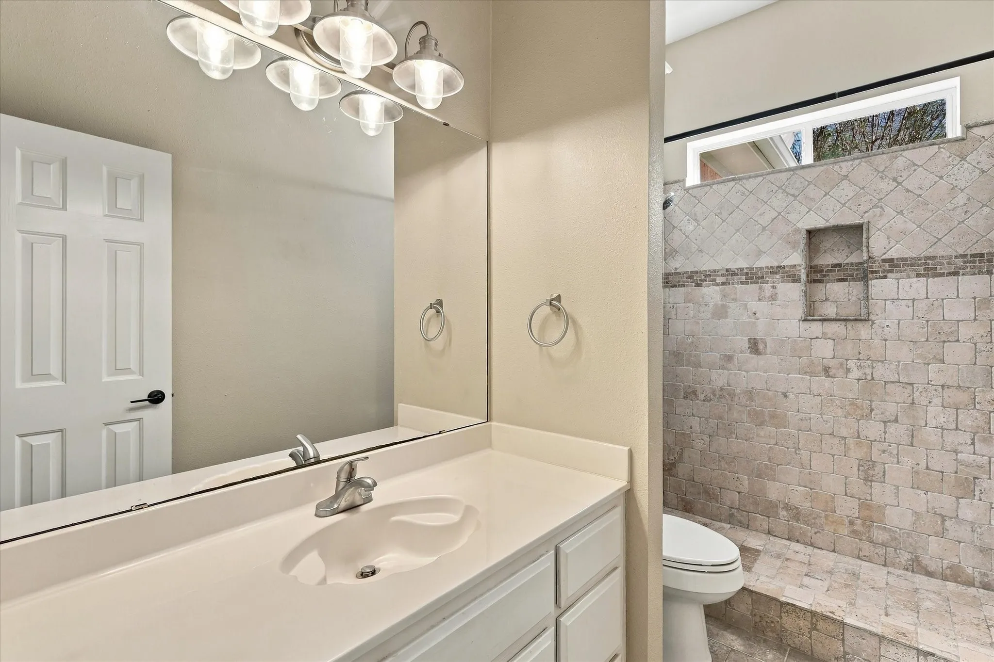 Single vanity with an integrated sink, polished chrome faucet, and white cabinetry