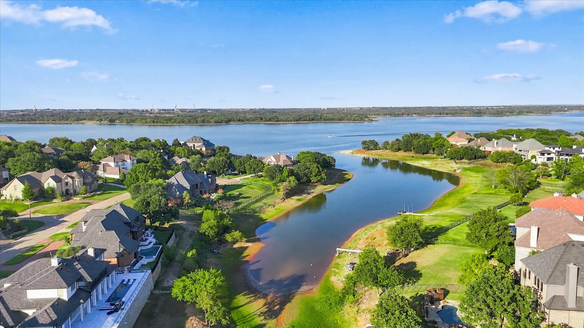 Expansive waterfront setting with mature trees and established residences