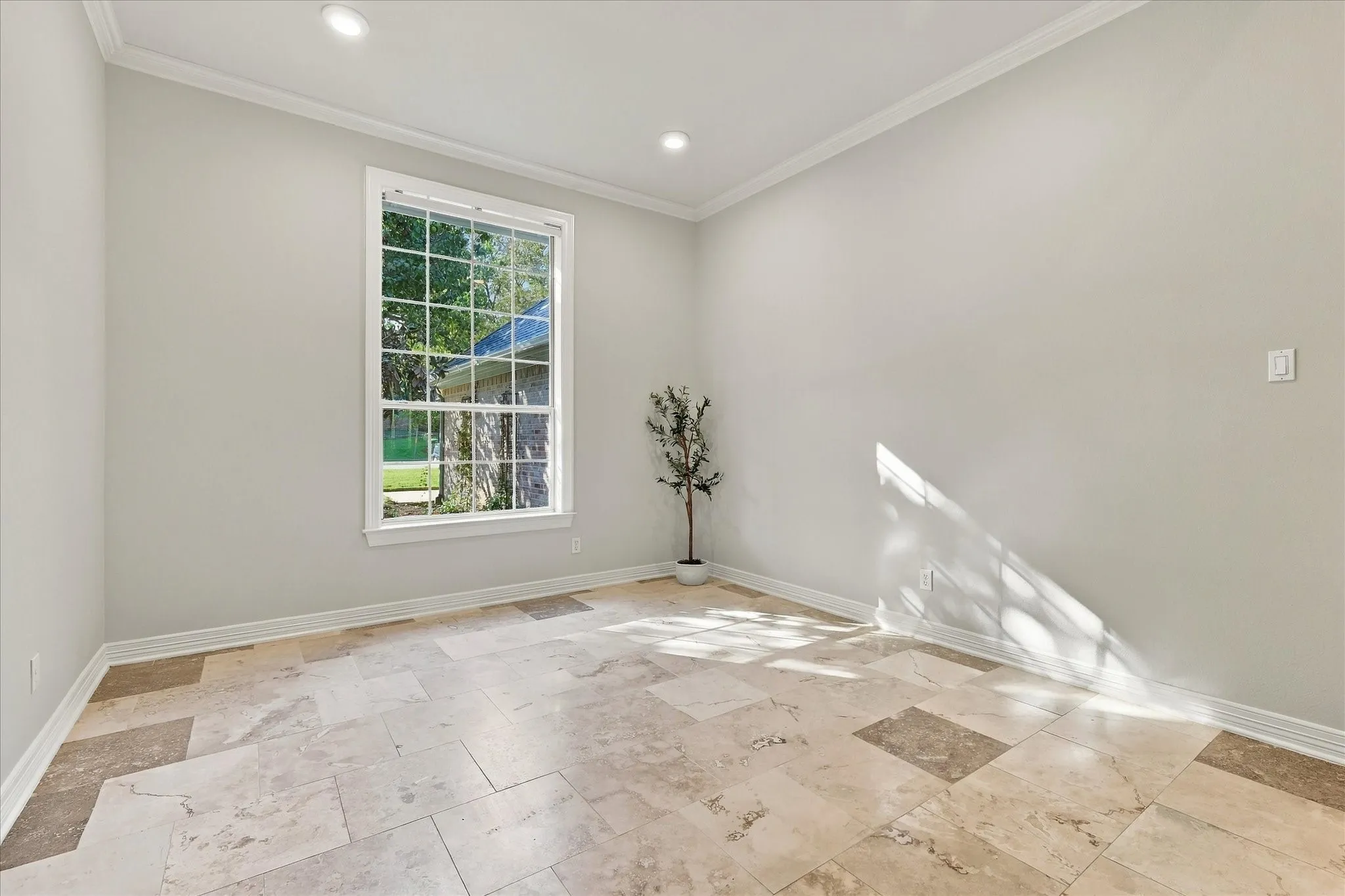 Recessed lighting, crown molding, large window, tile flooring, and light-toned walls