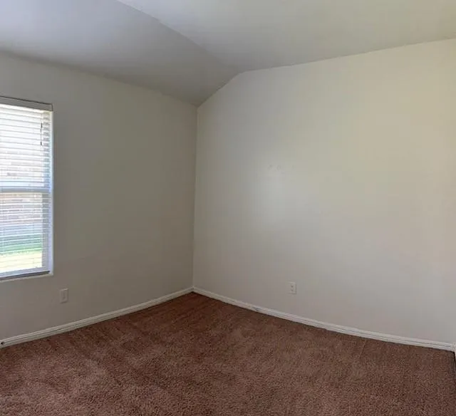 Neutral wall finishes and brown carpeting