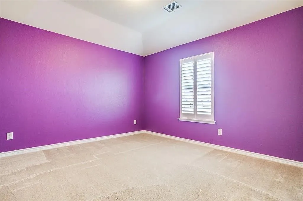 Recessed lighting, window with plantation shutters, light-toned carpeting, and tray ceiling