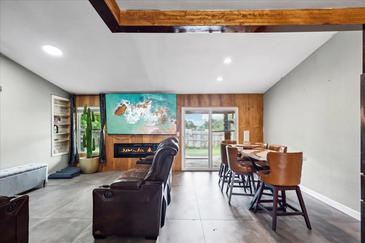 Wood-finish flooring throughout, recessed lighting, and a modern built-in fireplace