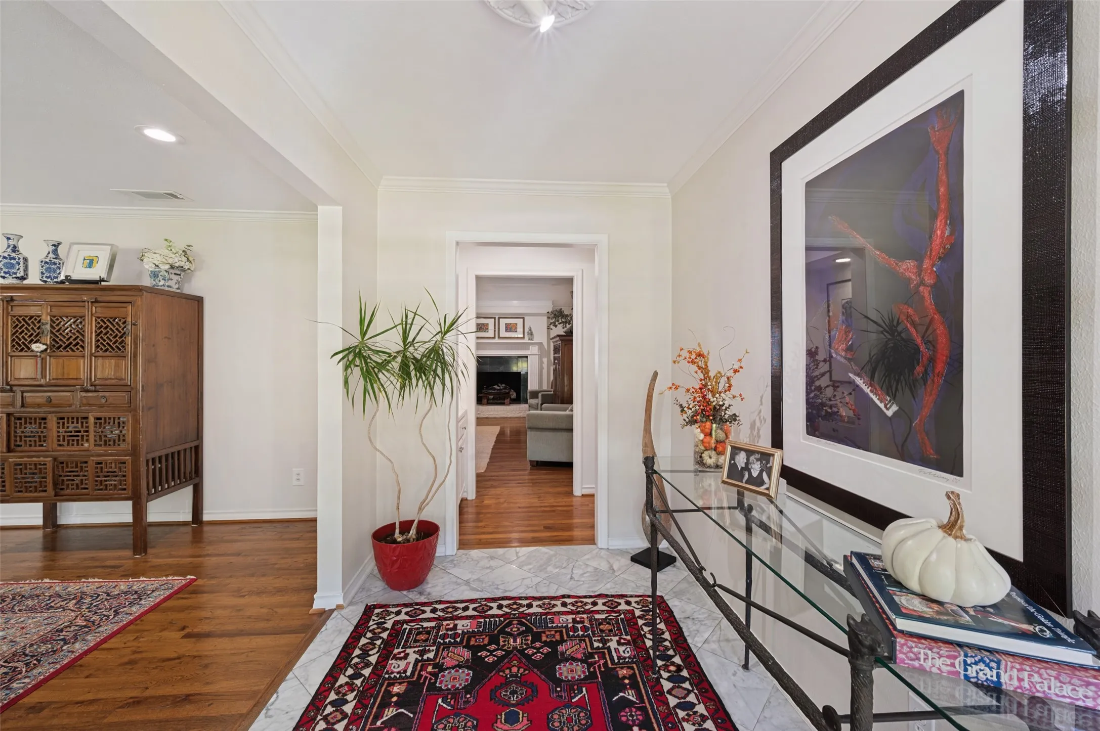 Foyer featuring marble flooring, hardwood flooring, and recessed lighting