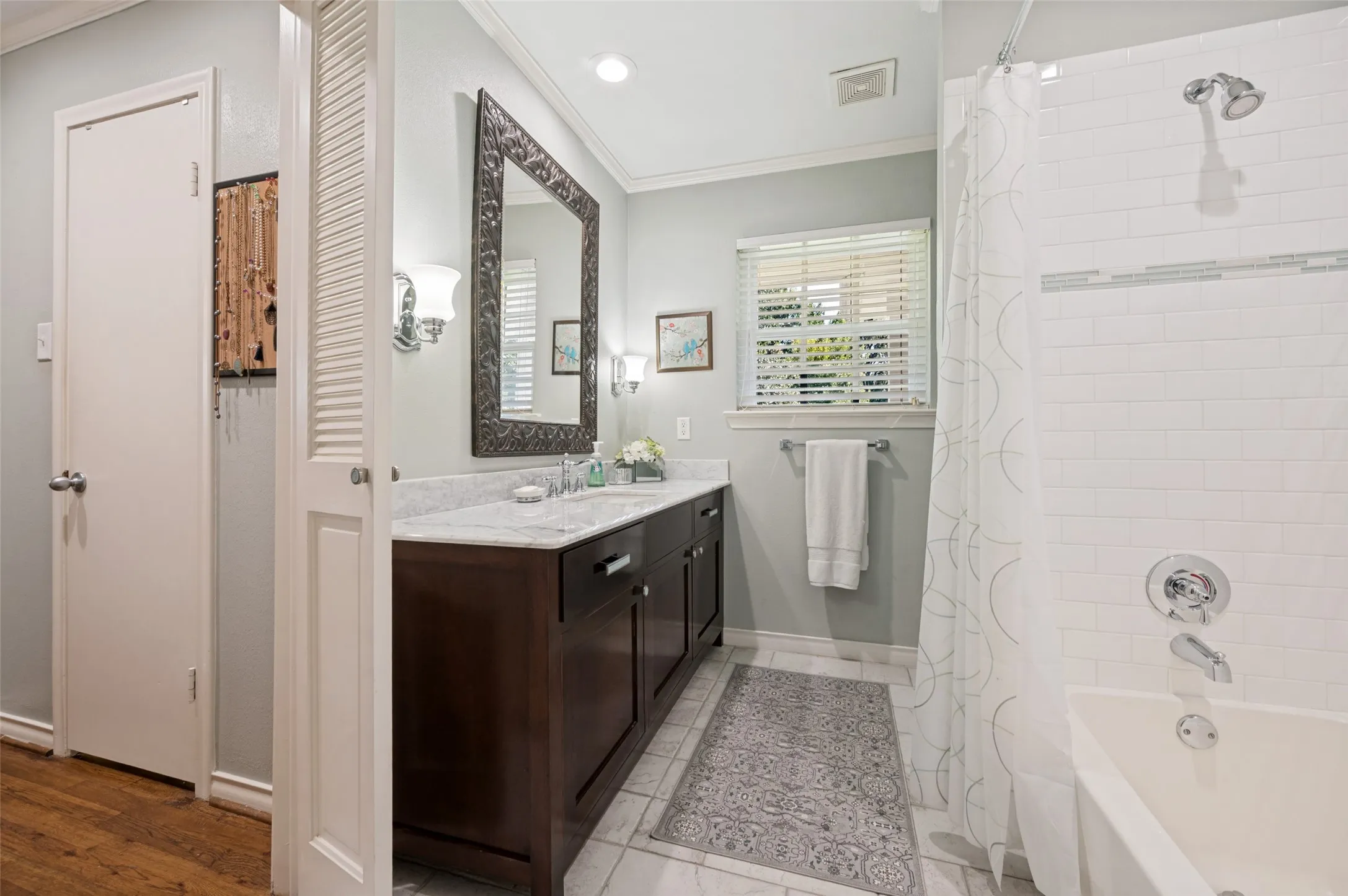 White marble countertops with an integrated sink, and dark wood-finish cabinetry