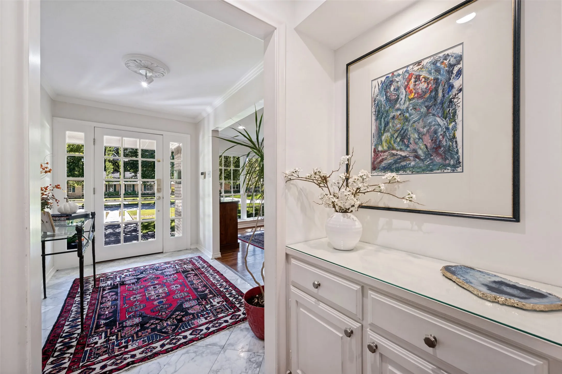Entryway featuring glass-paneled front door with sidelights, and a transom window