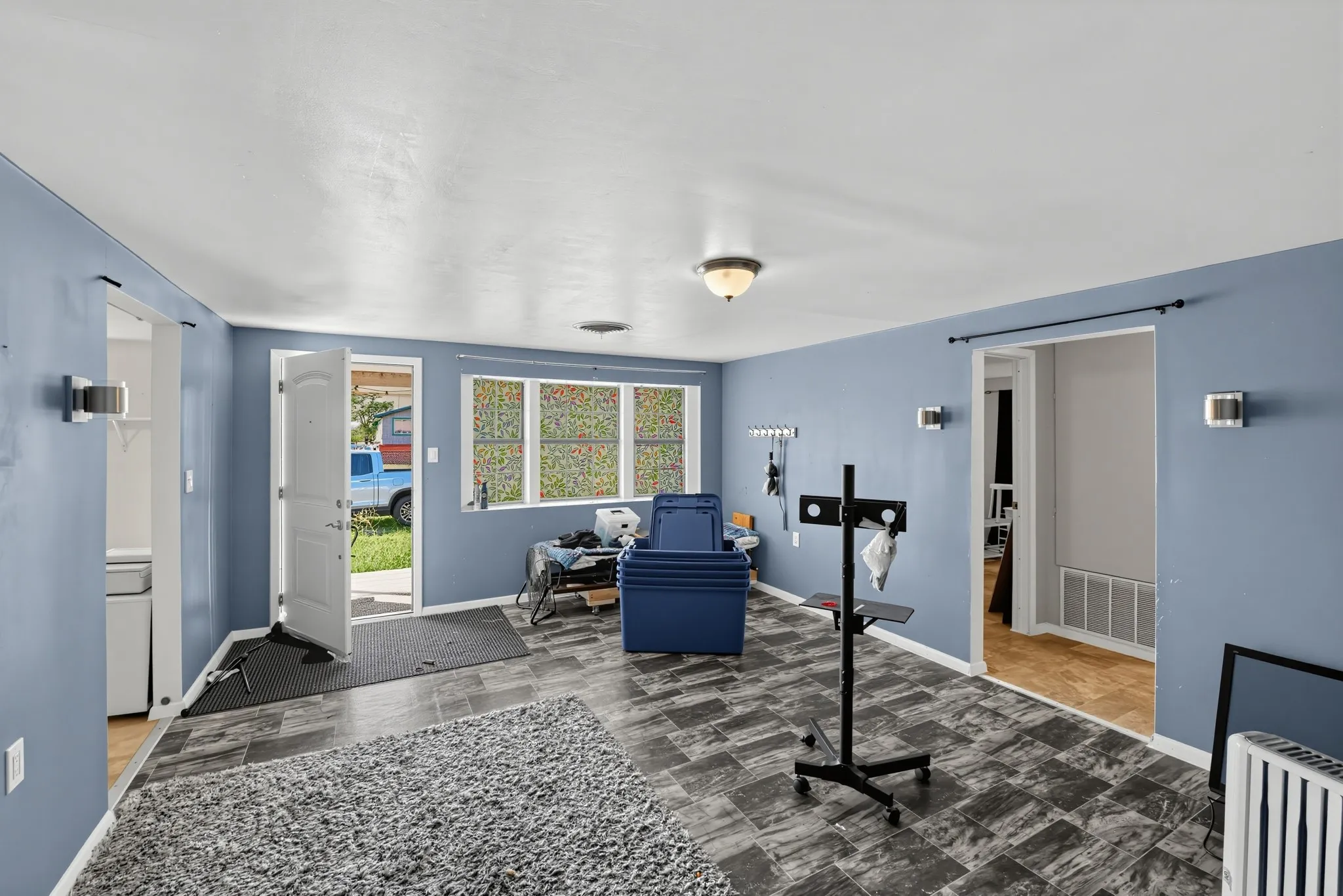 Patterned tile flooring, recessed ceiling lighting, wall-mounted sconces, and interior door frames