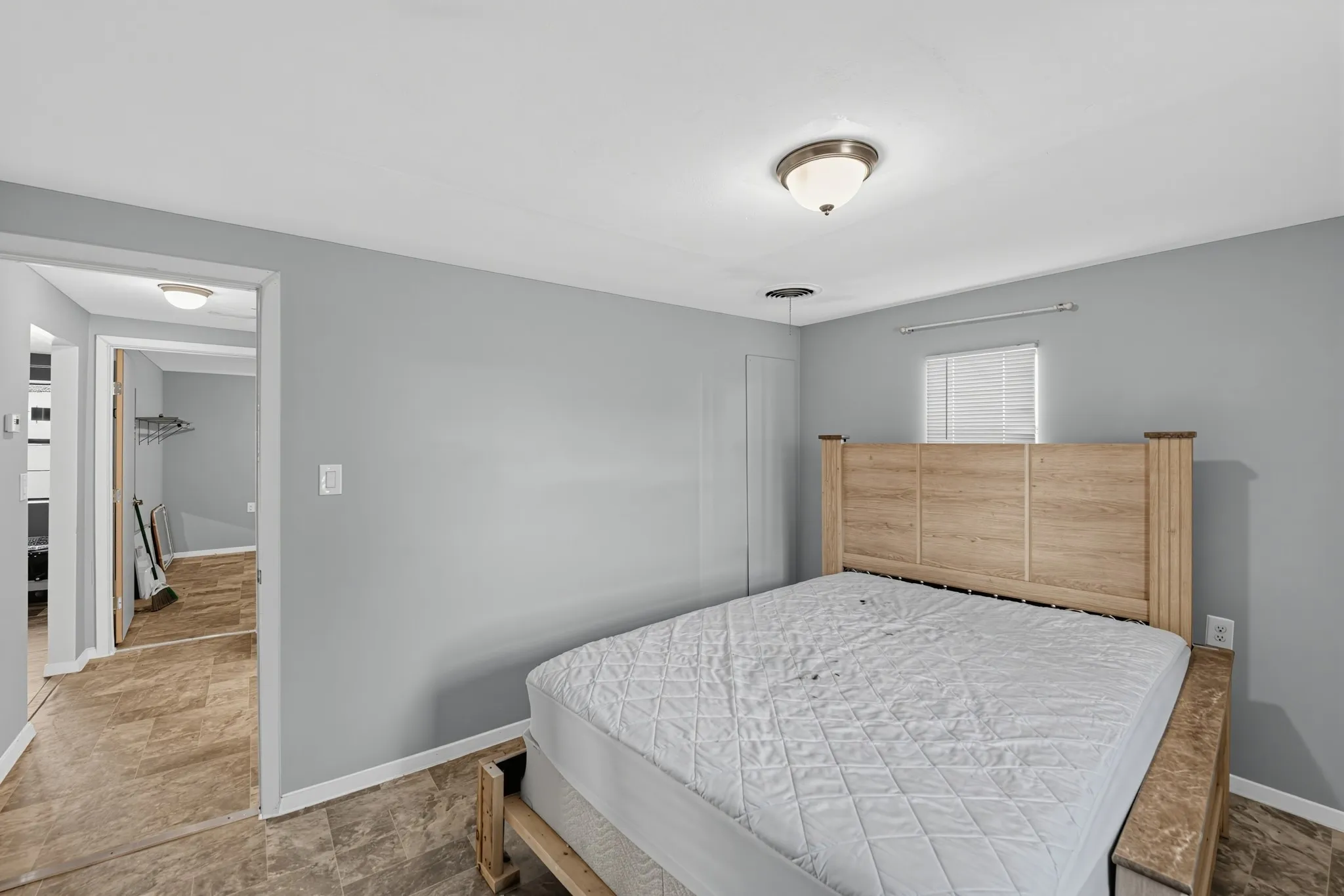 Recessed ceiling lighting, a window with blinds, and vinyl flooring