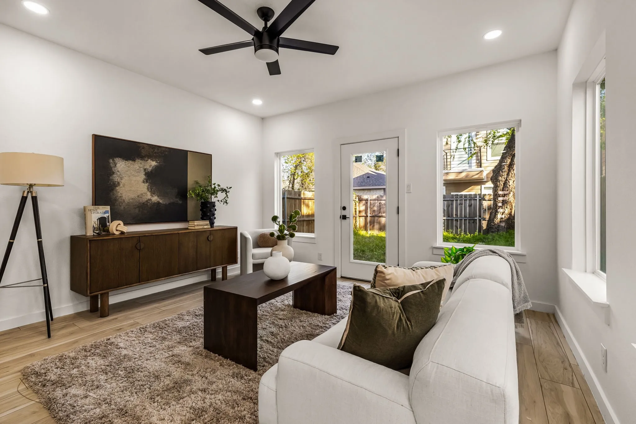 Recessed lighting, wood-finish flooring, ceiling fan, multiple windows, and a glass-paneled door