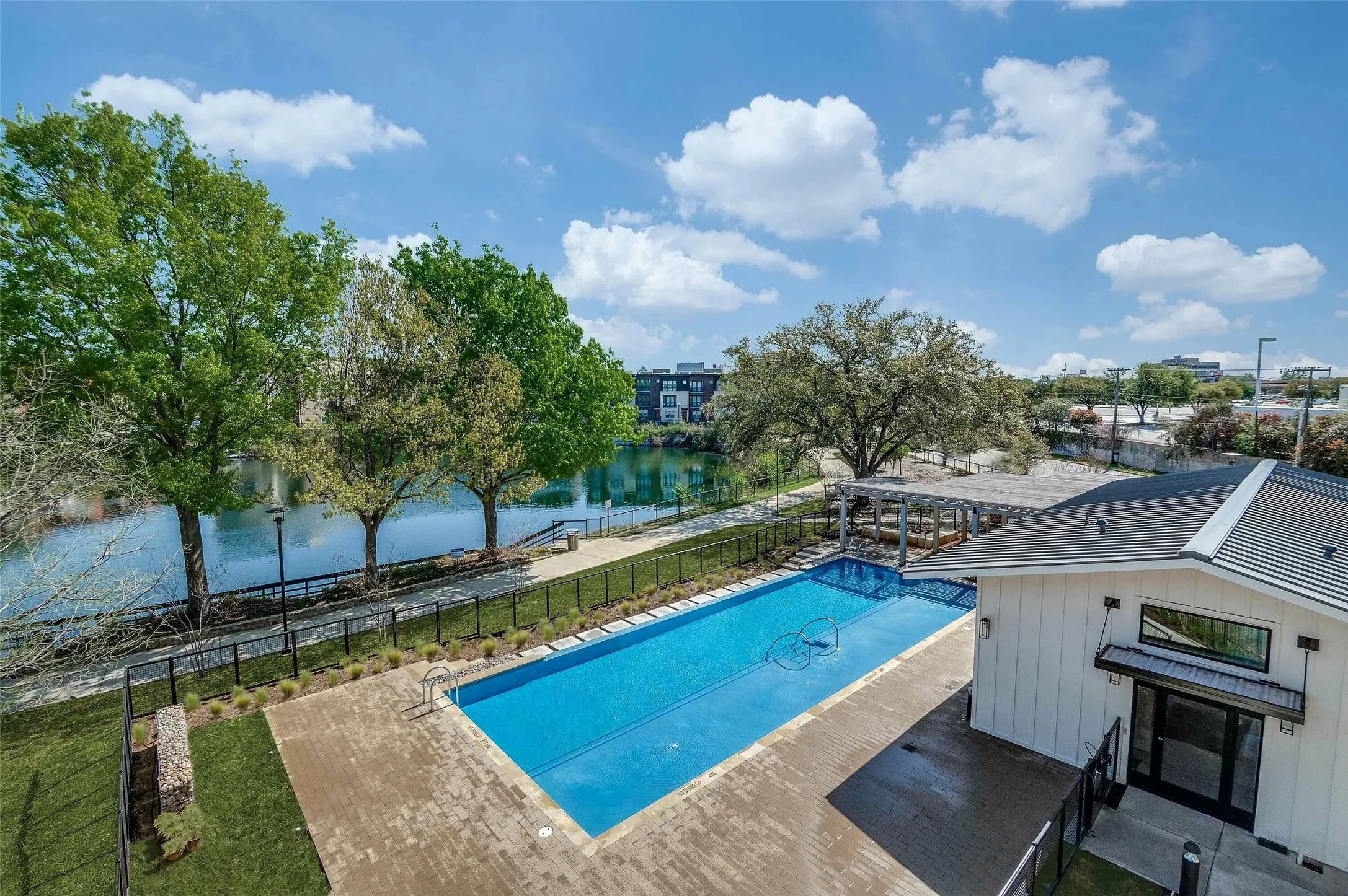 View of pool featuring a water view and a patio area
