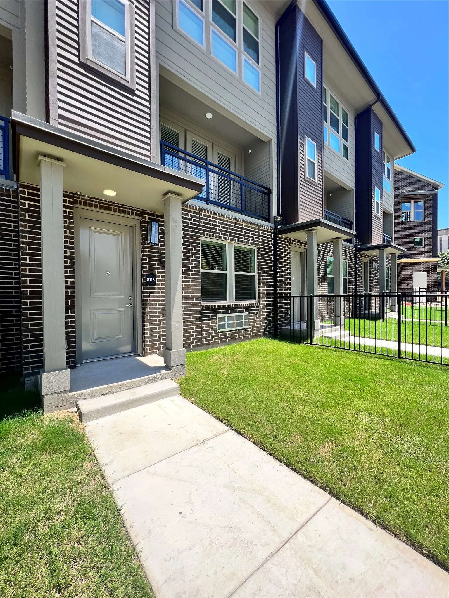 Multi-story facade featuring brick and horizontal siding