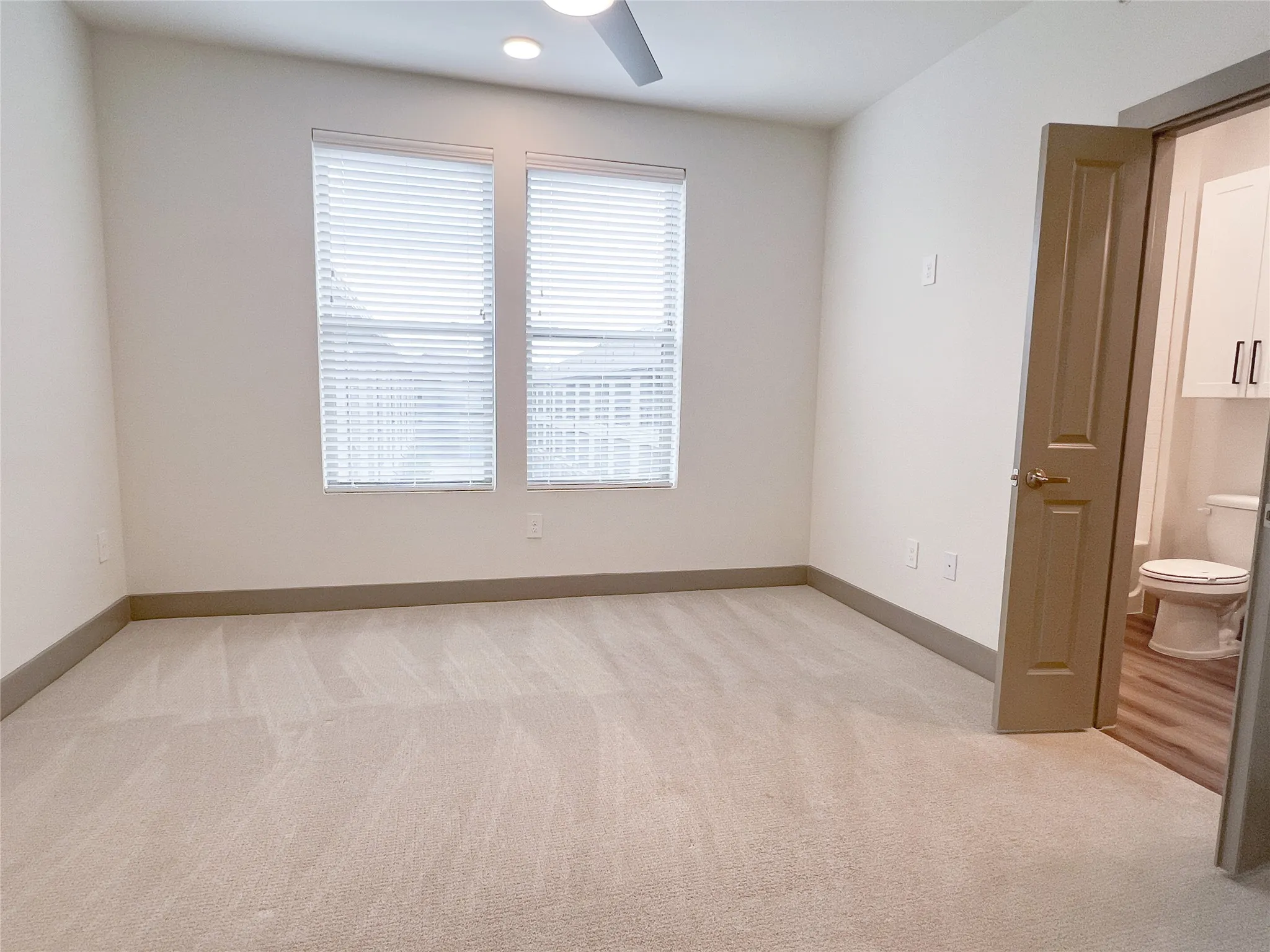 Spare room with light carpet and recessed lighting