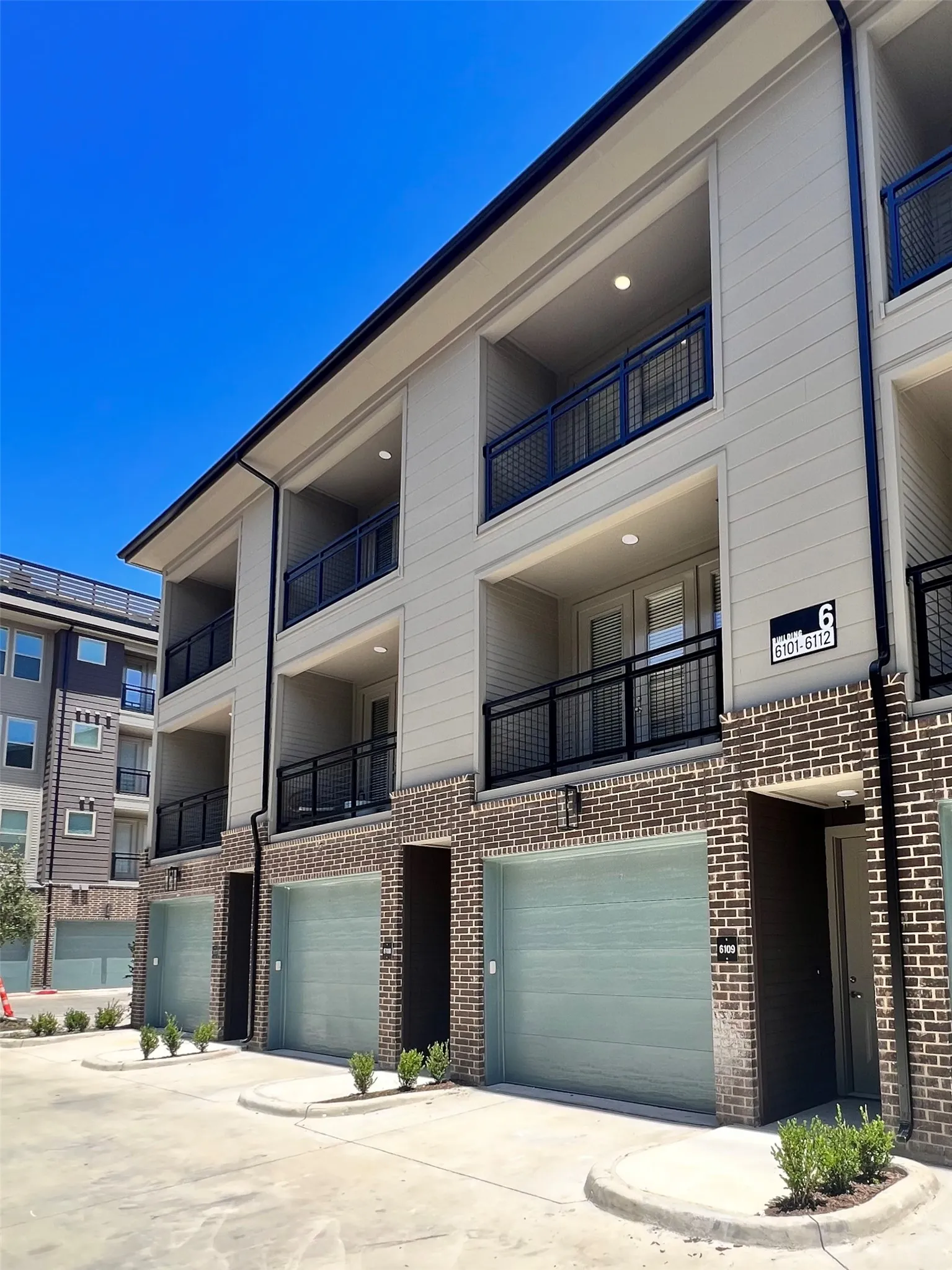 View of building exterior with driveway and an attached garage