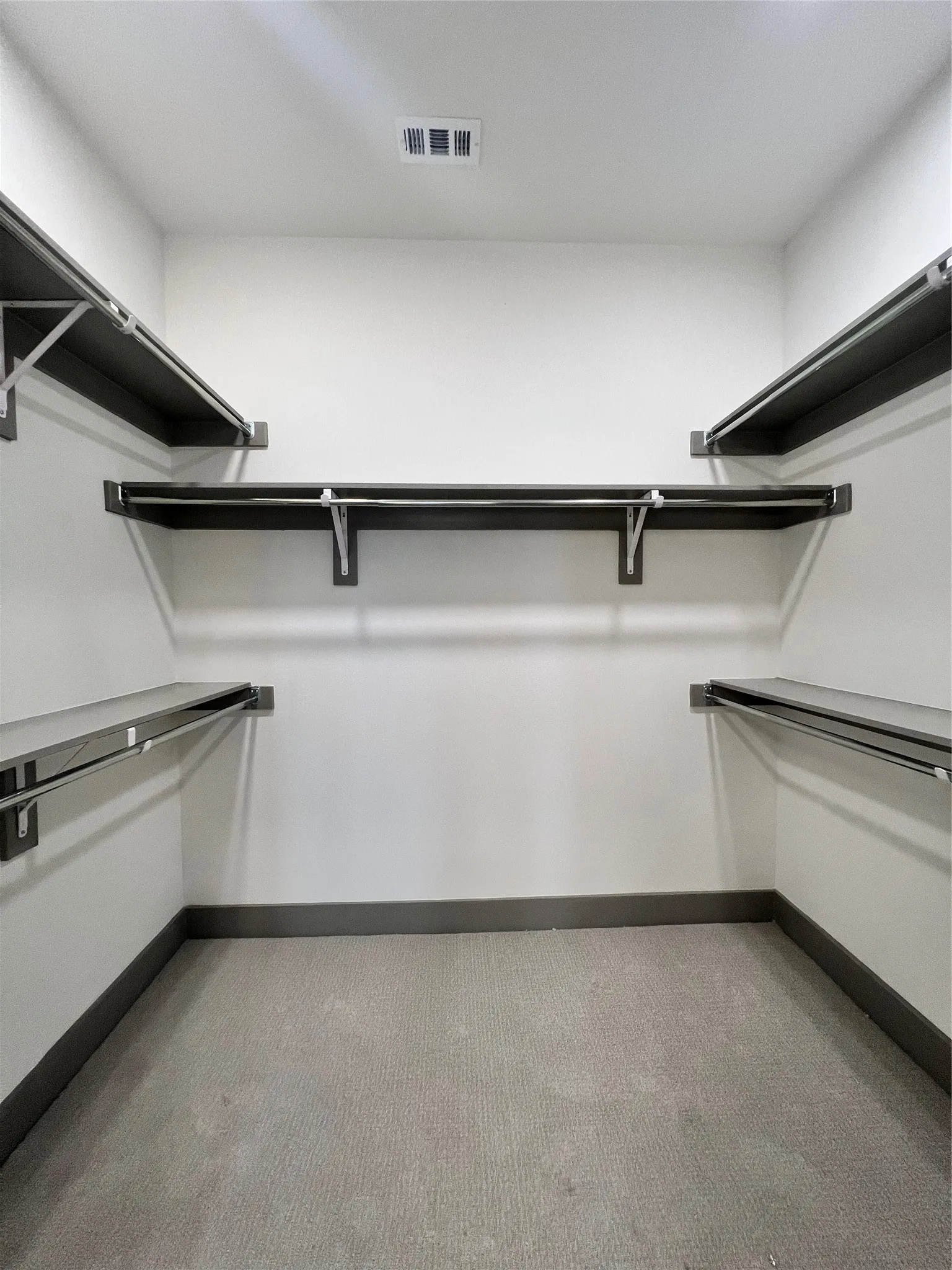 Walk in closet with light carpet