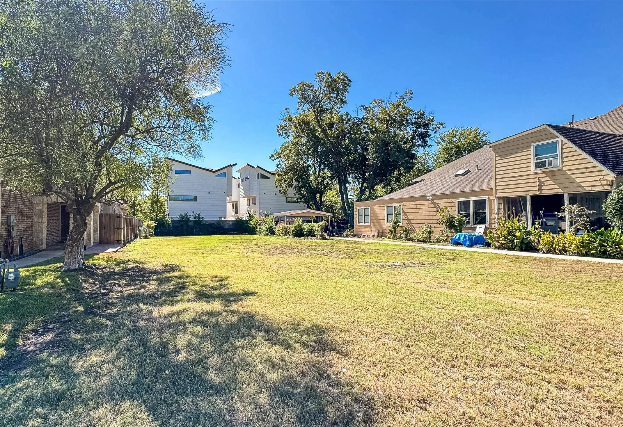 Expansive grassy yard with mature trees