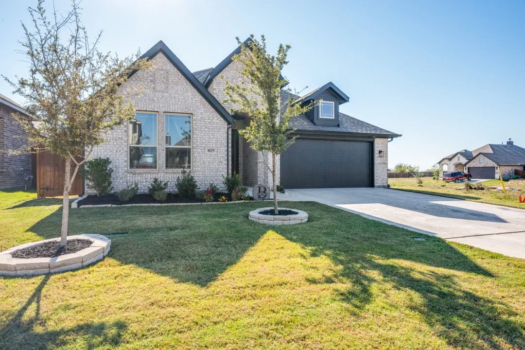 Gray brick exterior with dark trim and a gabled roofline