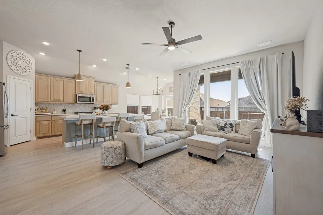 Open-concept living space featuring wood-finish flooring, recessed lighting, and a ceiling fan