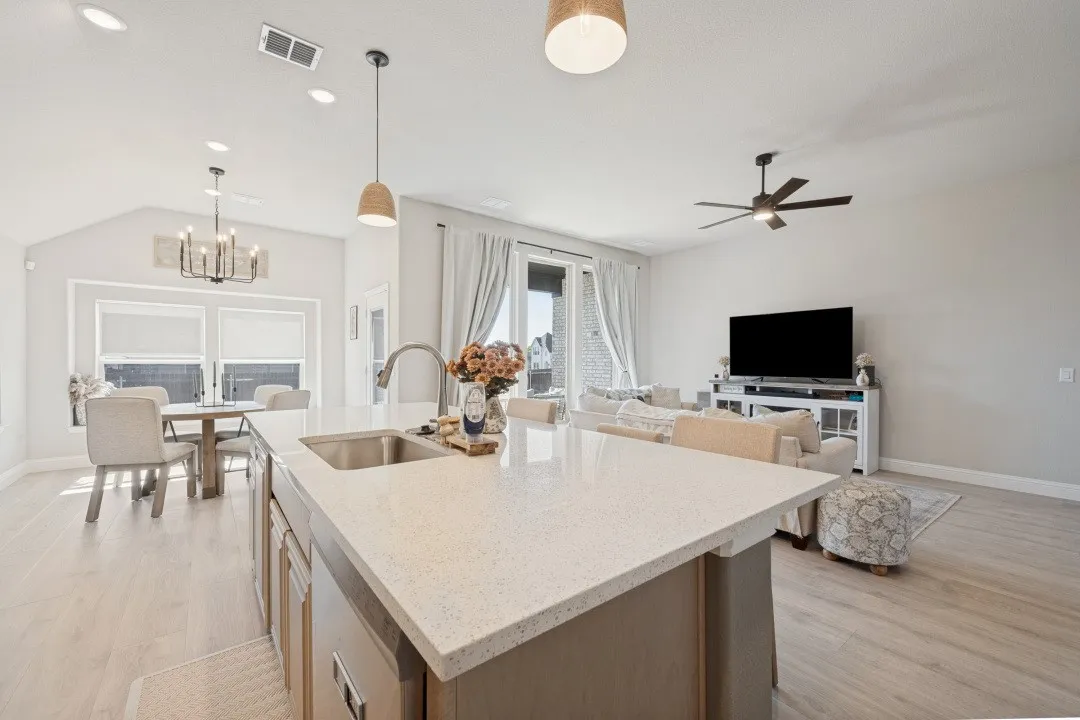 Kitchen island with an undermount sink and a light-colored countertop