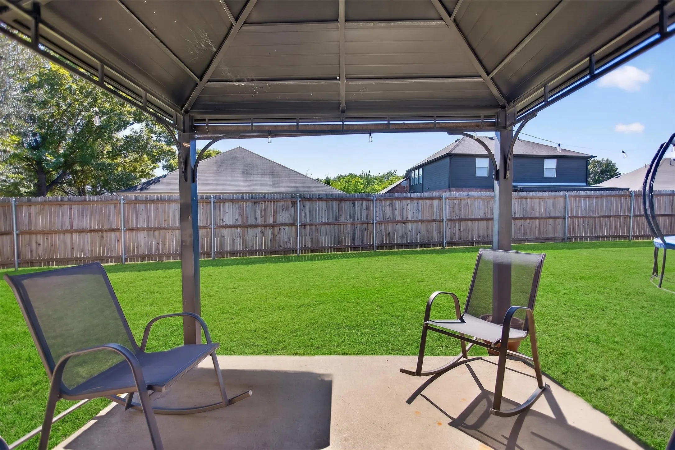 Pergola covered patio in huge backyard