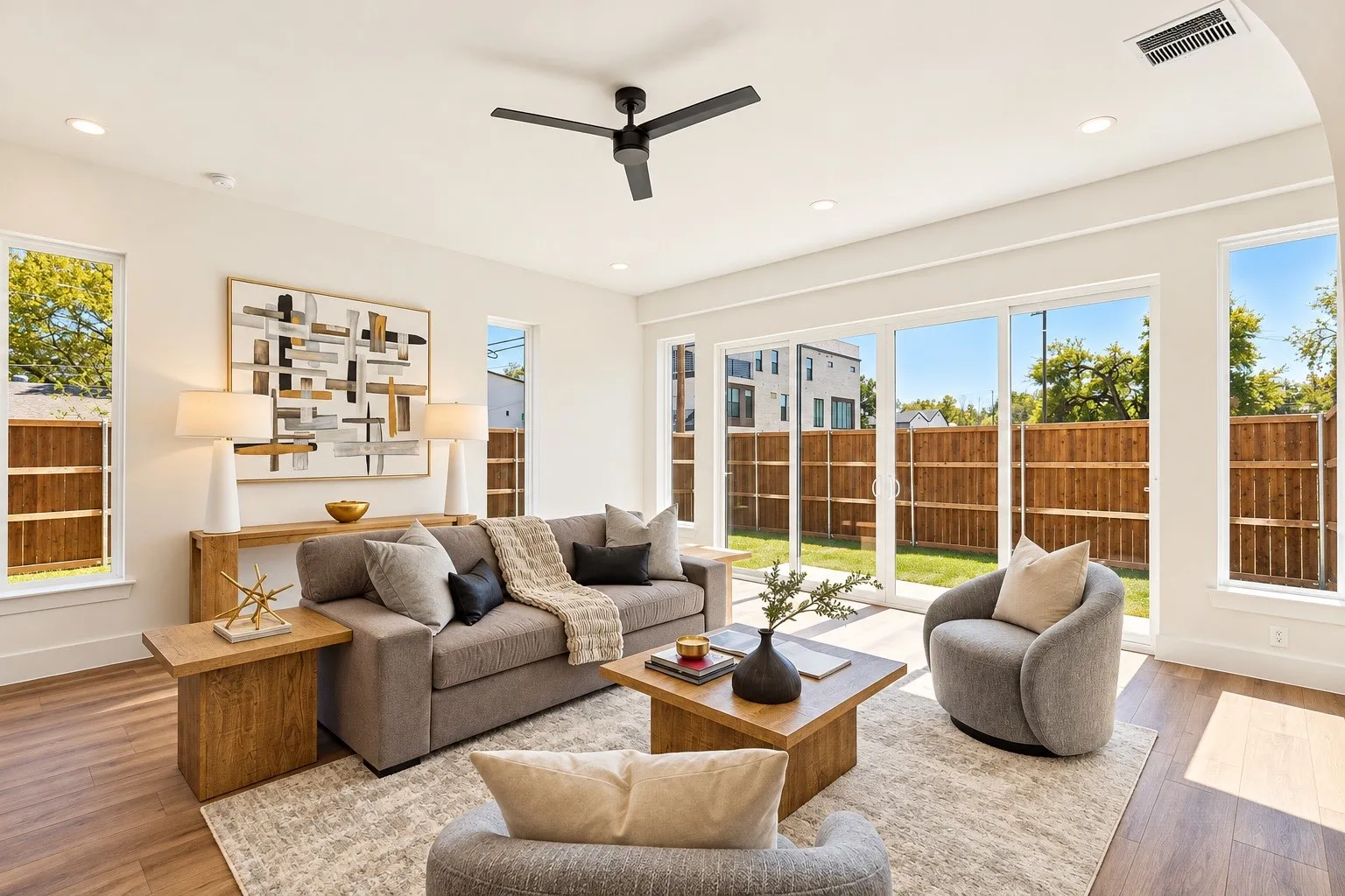 Spacious living area featuring wood-finish flooring, recessed lighting, and a modern ceiling fan